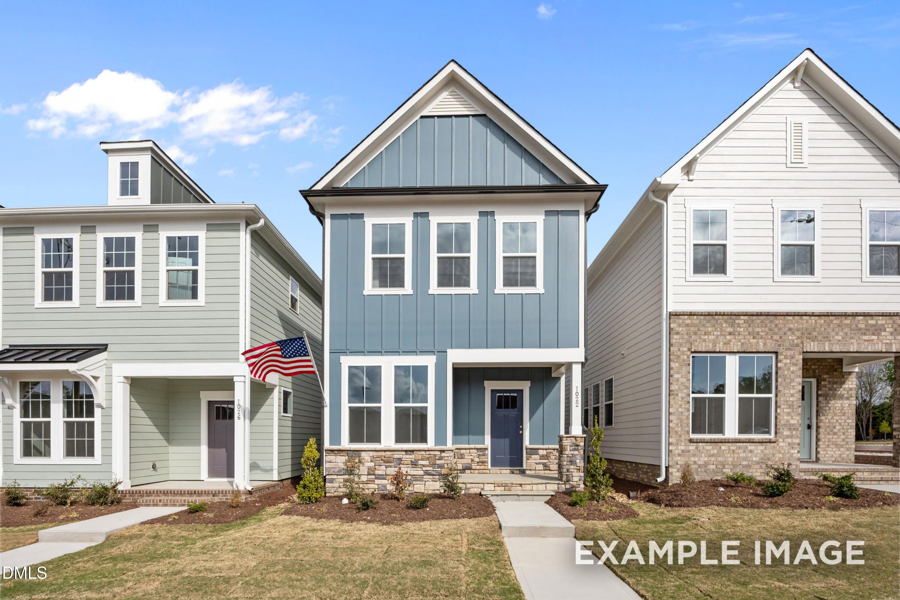 Two-story Alexander B floor plan by Davidson Homes with blue siding and stone exterior in Forestville Yard, Knightdale, NC.