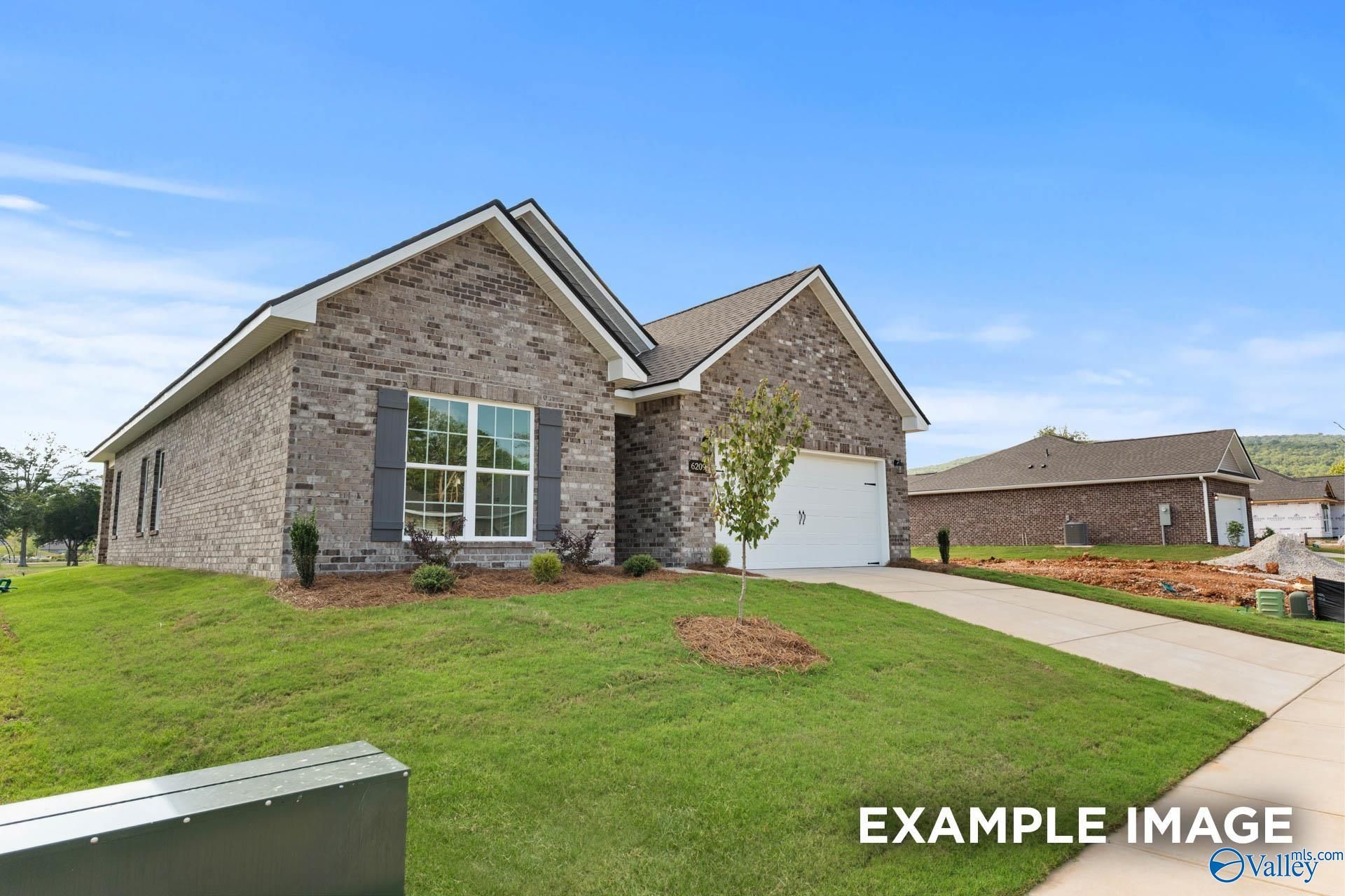 Brick single-story home with 2-car garage, brick facade, and landscaped yard in Wood Trail, Toney, Alabama - Davidson Homes Franklin C