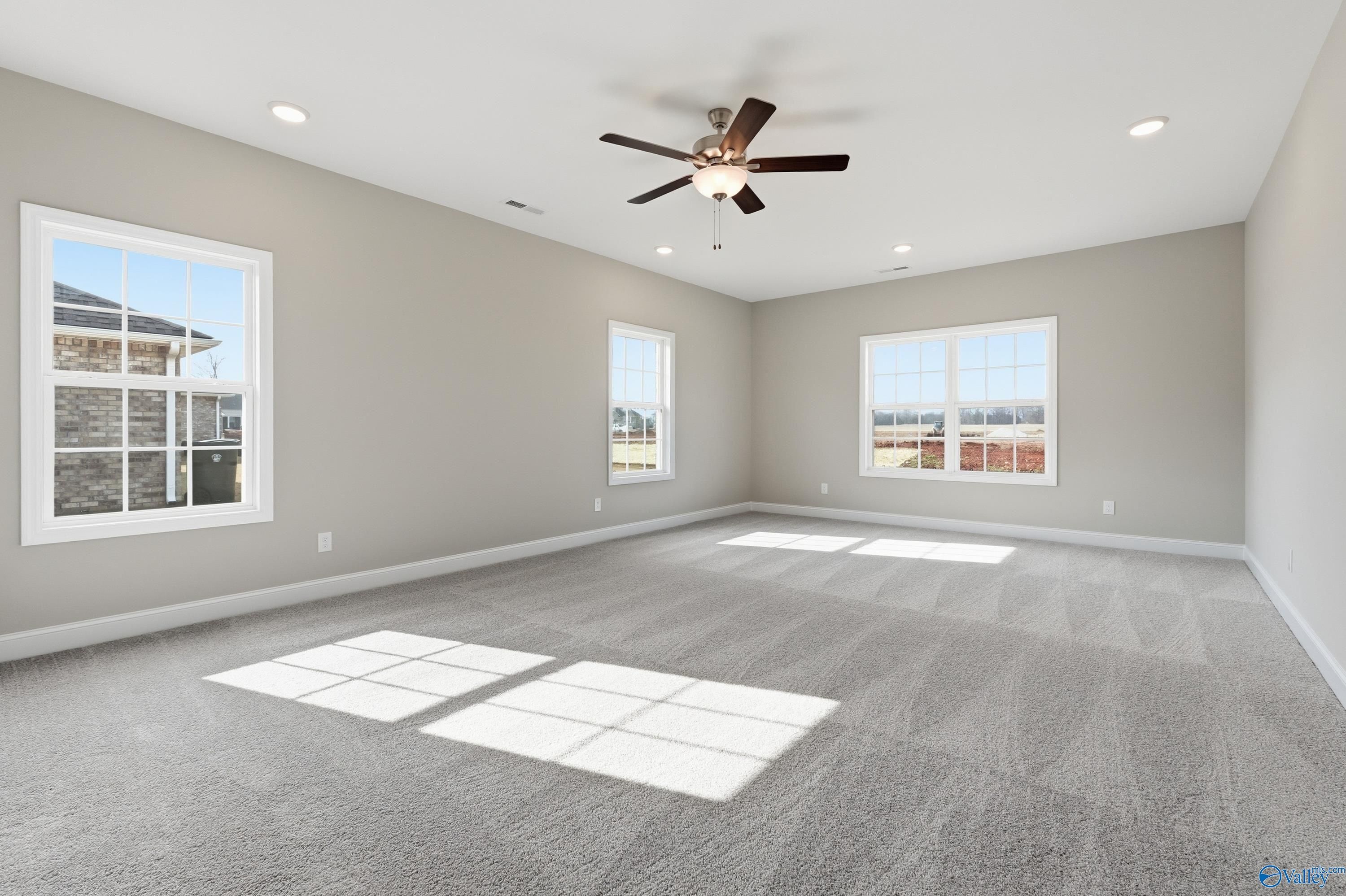 Bright spacious bedroom with large windows, natural light, ceiling fan in The Lanier by Davidson Homes, Meridianville, AL