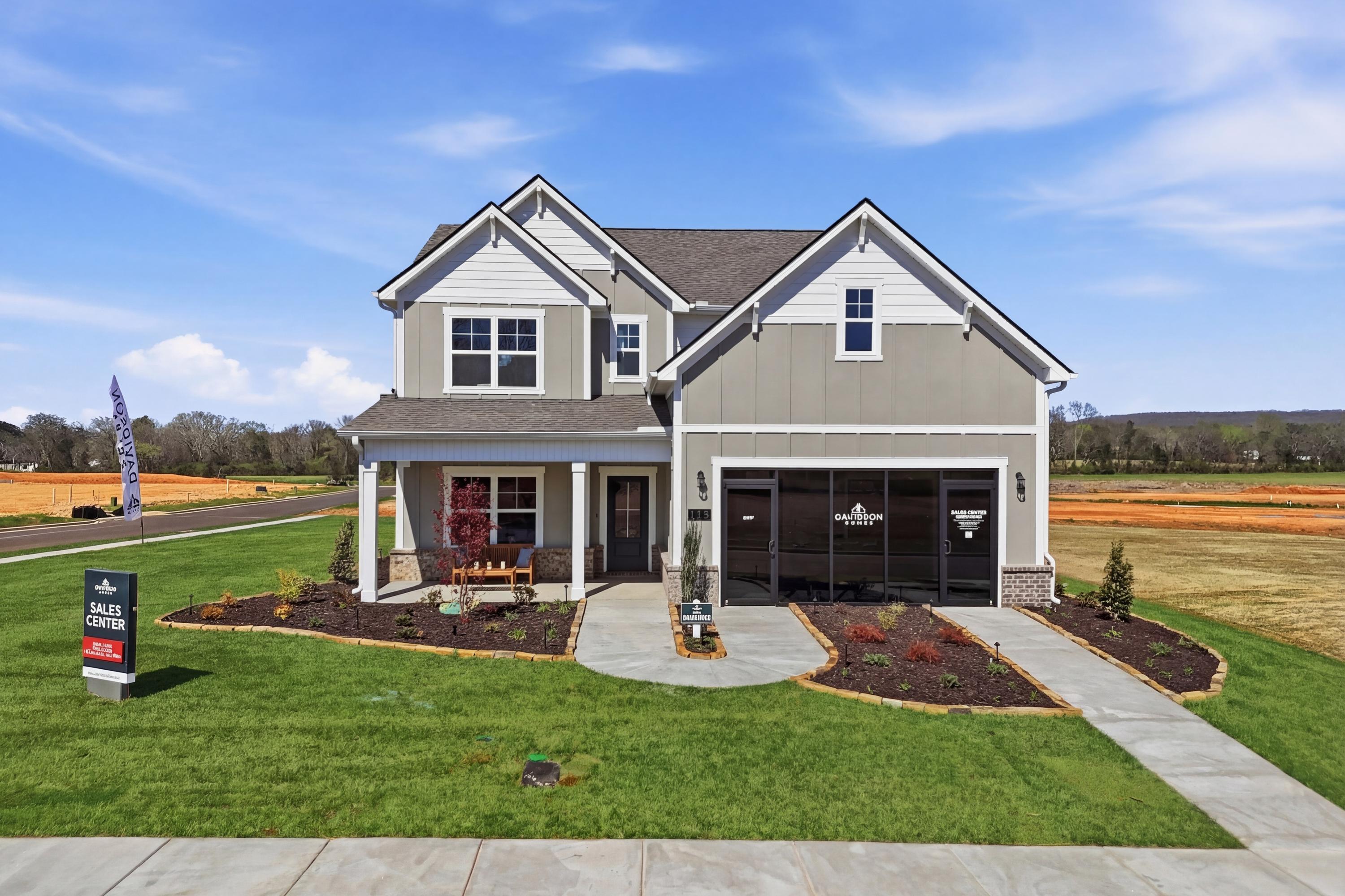 Modern two-story Craftsman home at Berry Cove in New Market Alabama with covered porch, garage, and landscaped yard