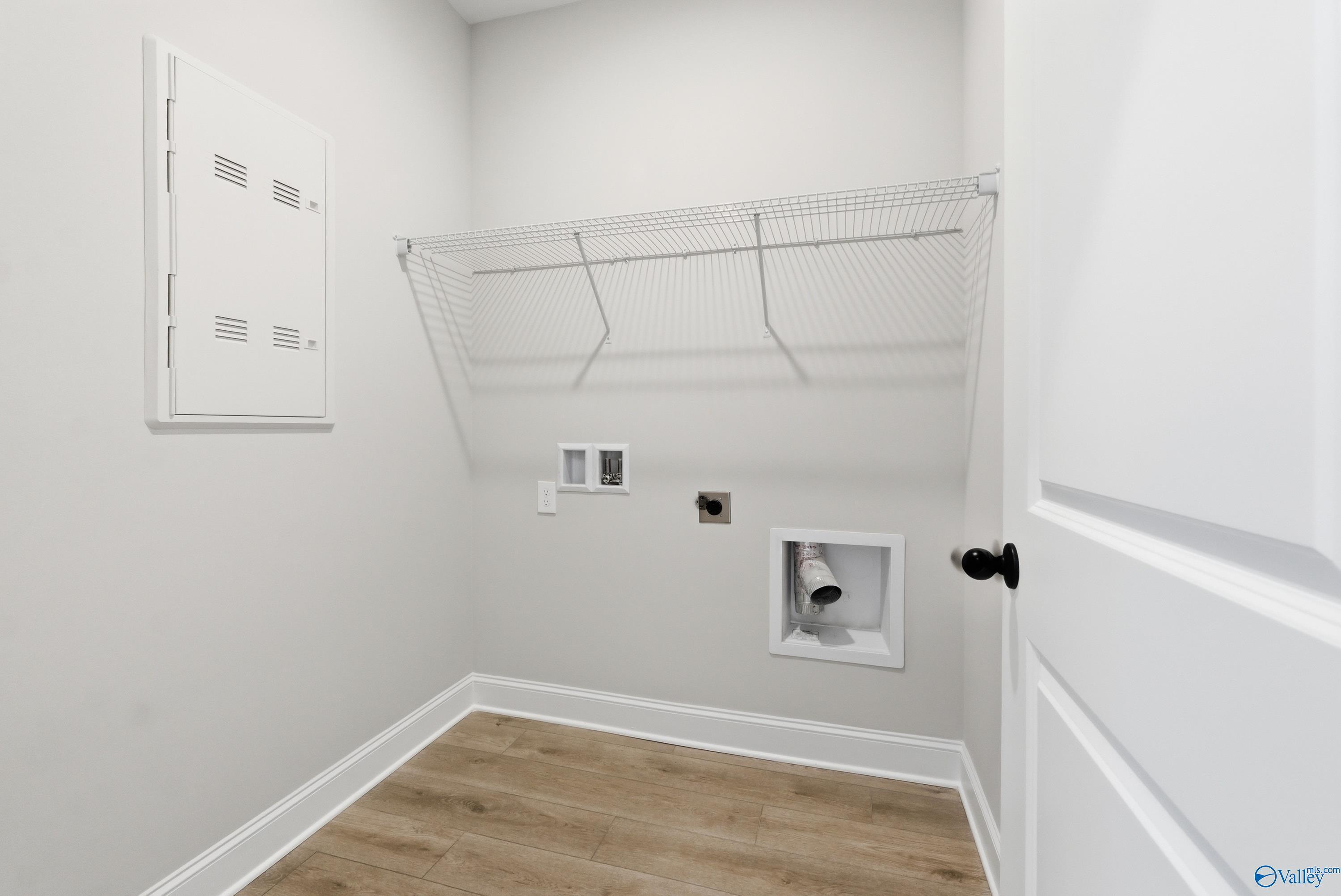 Spacious laundry room with wire shelving, washer/dryer hookups in Davidson Homes The Franklin C, New Market, Alabama