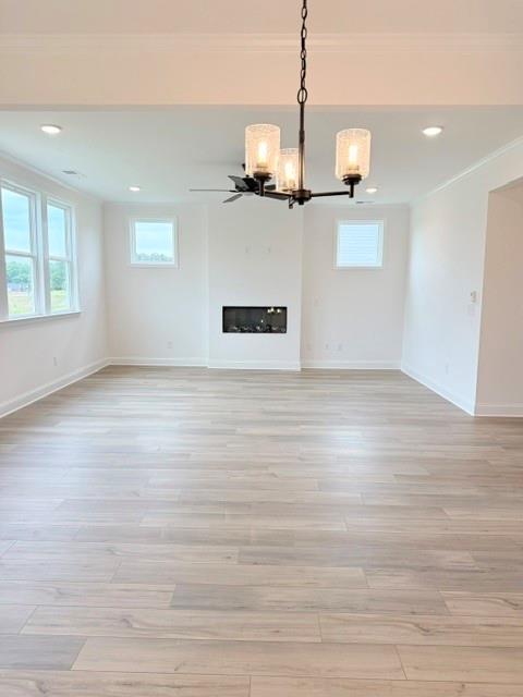 Spacious open-concept living room with modern fireplace in The Hickory B floor plan at Wehunt Meadows, Hoschton, Georgia.