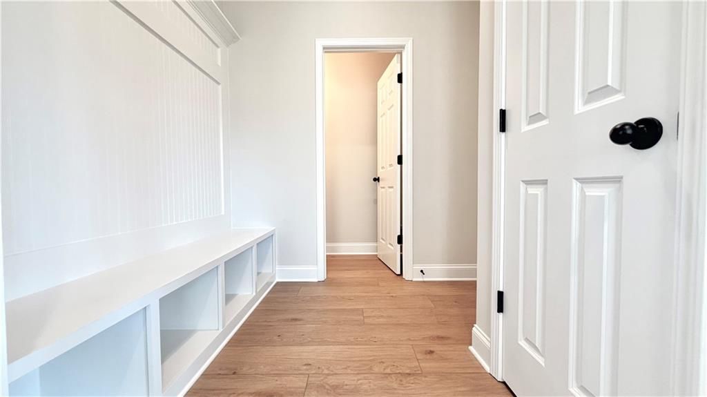 Mudroom with custom white built-in storage bench in The Glenwood A floor plan at Wehunt Meadows, Hoschton, Georgia.