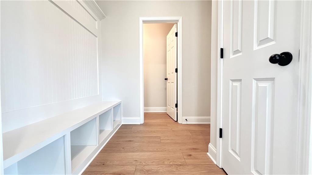 Mudroom with custom white built-in storage bench in The Glenwood A floor plan at Wehunt Meadows, Hoschton, Georgia.