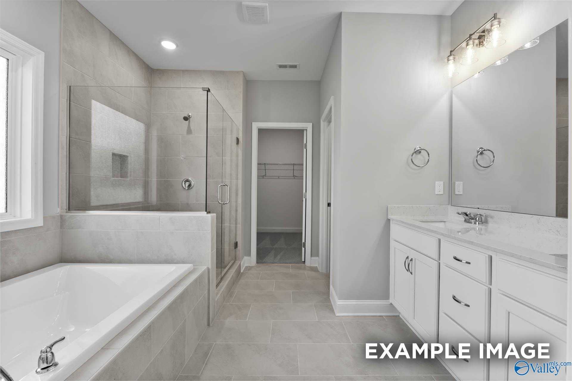Modern master bathroom with glass shower, soaking tub, double vanity in Davidson Homes The Rockford D, Hazel Green, AL