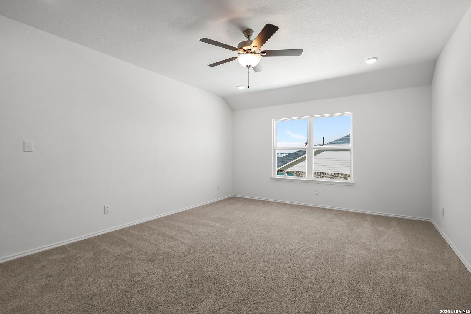 Bright empty bedroom with ceiling fan, large window, and beige carpet in Davidson Homes The Sequoia B, San Antonio