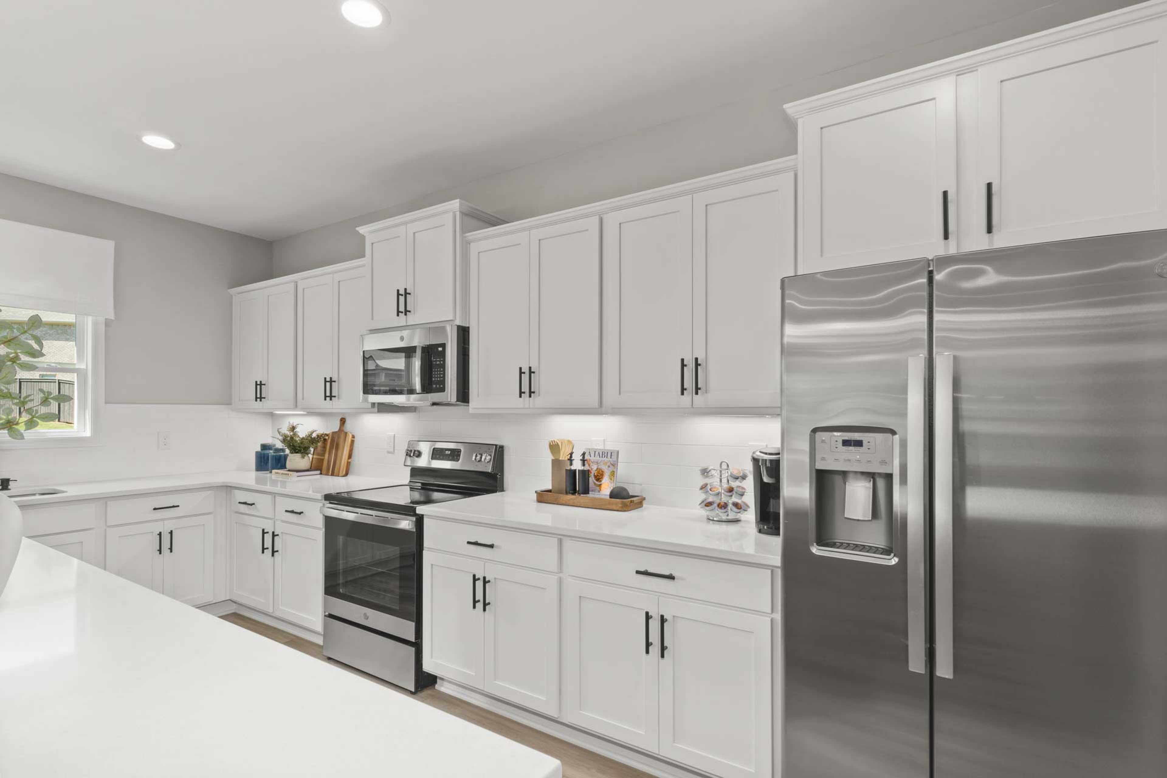 Spacious modern kitchen at Creek Grove in New Market Alabama with white shaker cabinets, stainless steel appliances, and large island