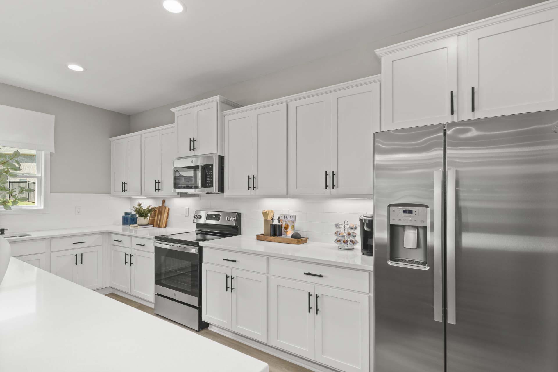 Spacious modern kitchen at Creek Grove in New Market Alabama with white shaker cabinets, stainless steel appliances, and large island