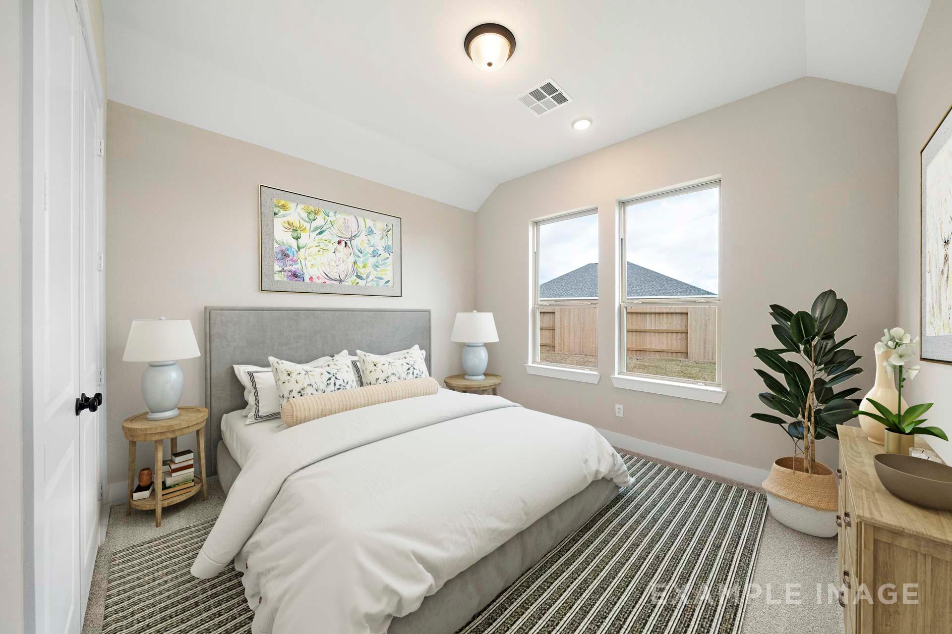 Spacious master bedroom in The Elizabeth A with king bed, beige walls, large windows, and potted plants
