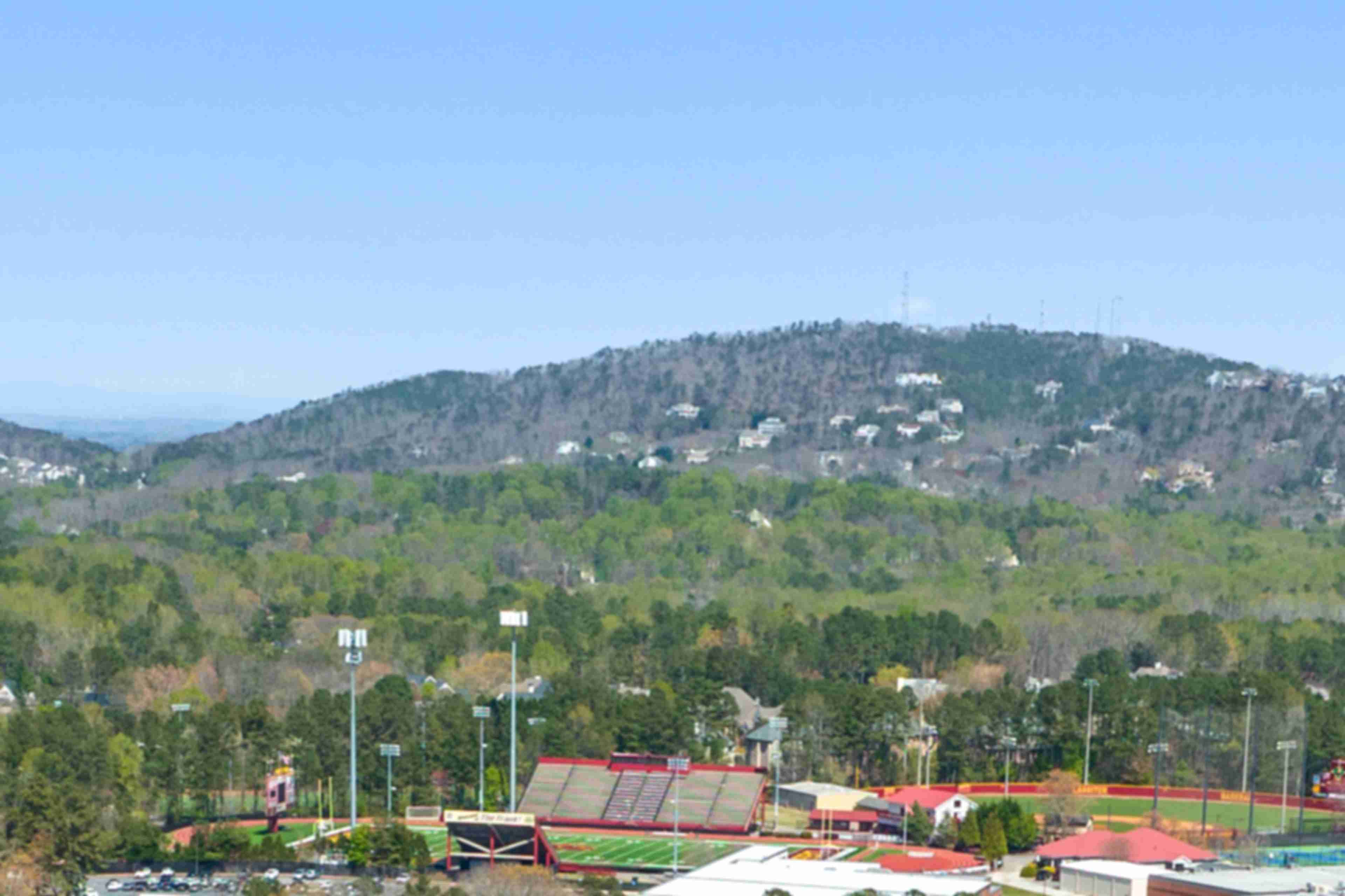 Panoramic view of rolling hills, lush forests, tennis courts and homes at Lassiter Place in East Cobb, Georgia