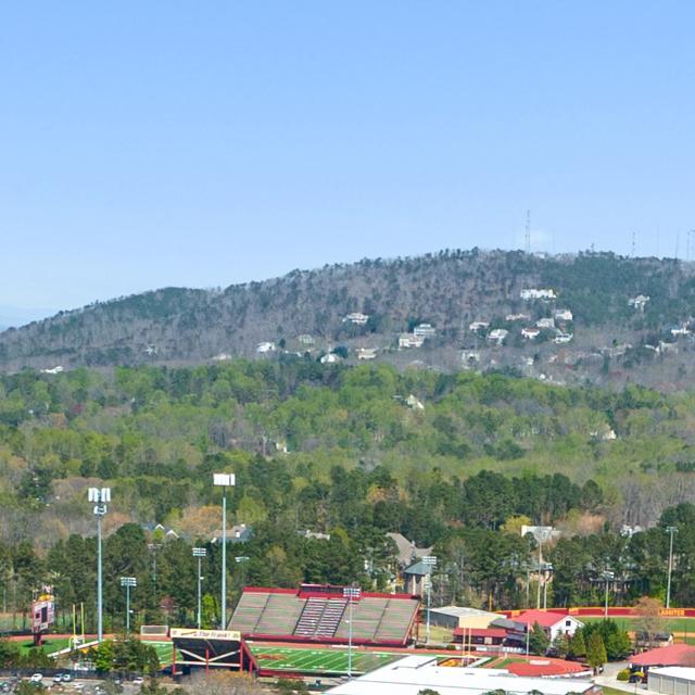 Panoramic view of rolling hills, lush forests, tennis courts and homes at Lassiter Place in East Cobb, Georgia