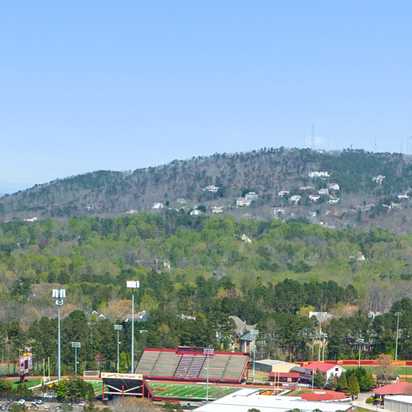 Panoramic view of rolling hills, lush forests, tennis courts and homes at Lassiter Place in East Cobb, Georgia
