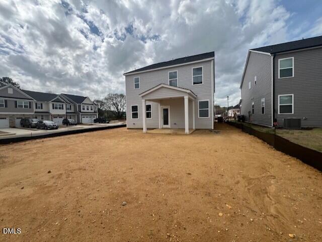Two-story 4-bedroom home with covered front porch and dirt yard in Gregory Village, Lillington, North Carolina by Davidson Homes