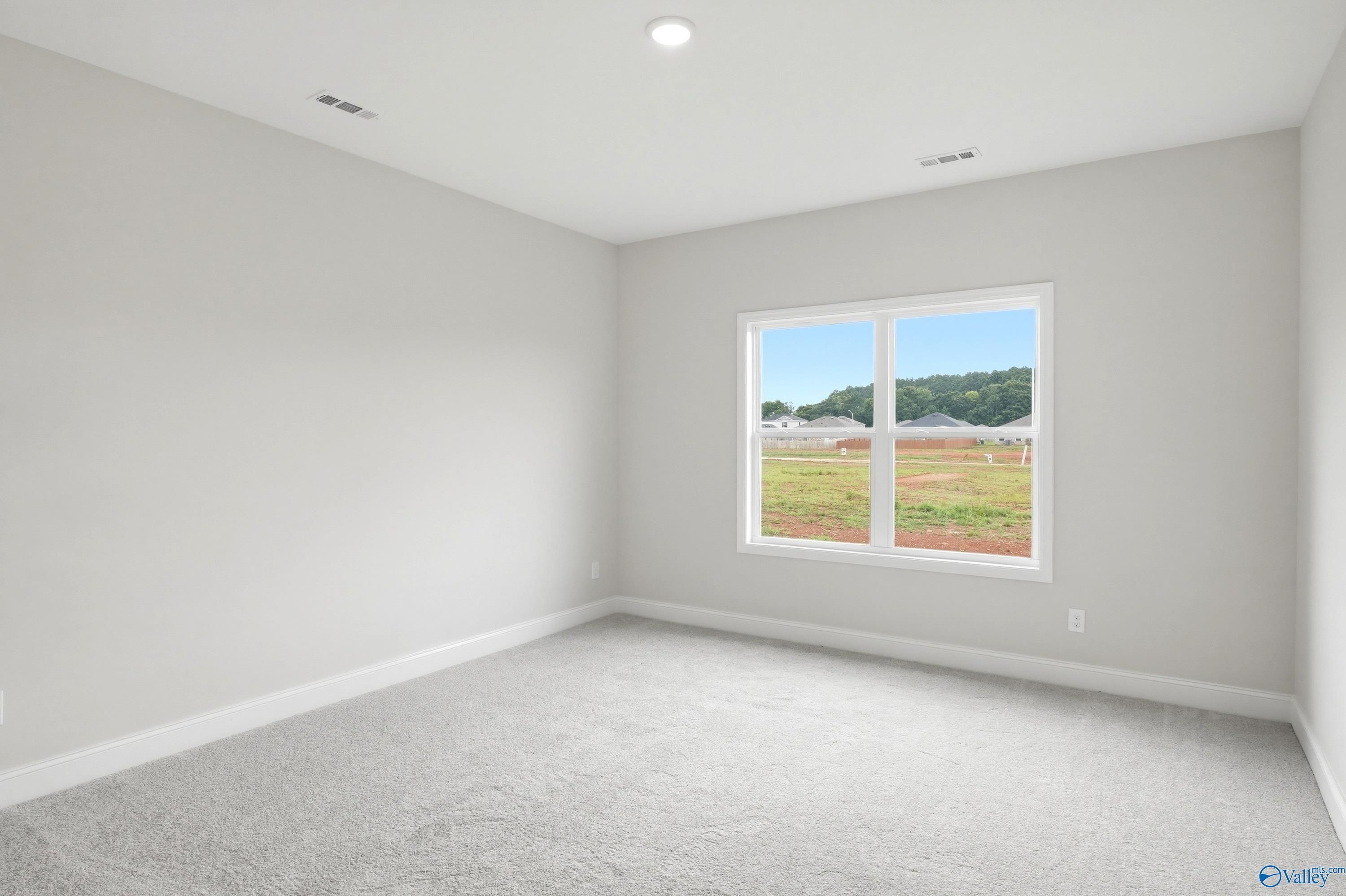 Bright, neutral-toned bedroom in The Daphne floor plan by Davidson Homes in Lynn Meadows, Meridianville, Alabama.