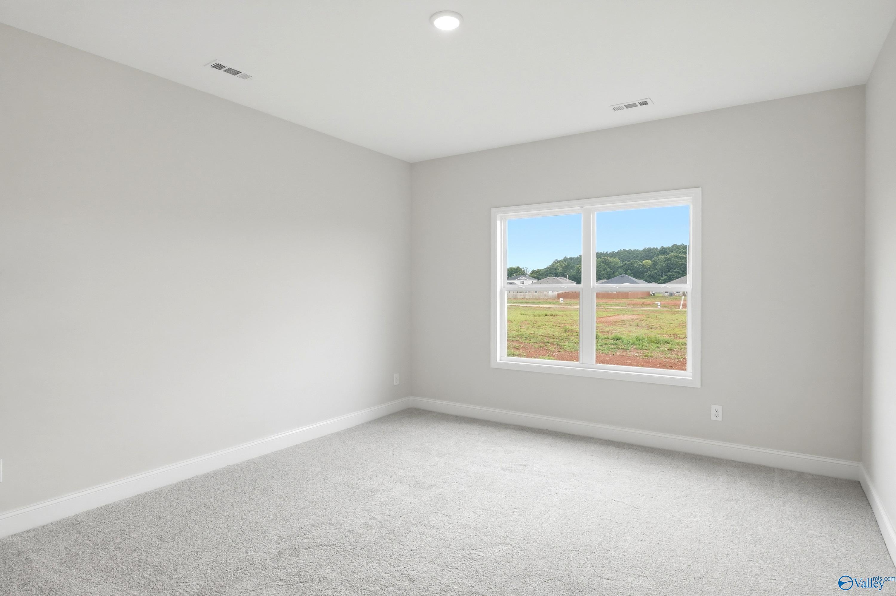 Bright, neutral-toned bedroom in The Daphne floor plan by Davidson Homes in Lynn Meadows, Meridianville, Alabama.