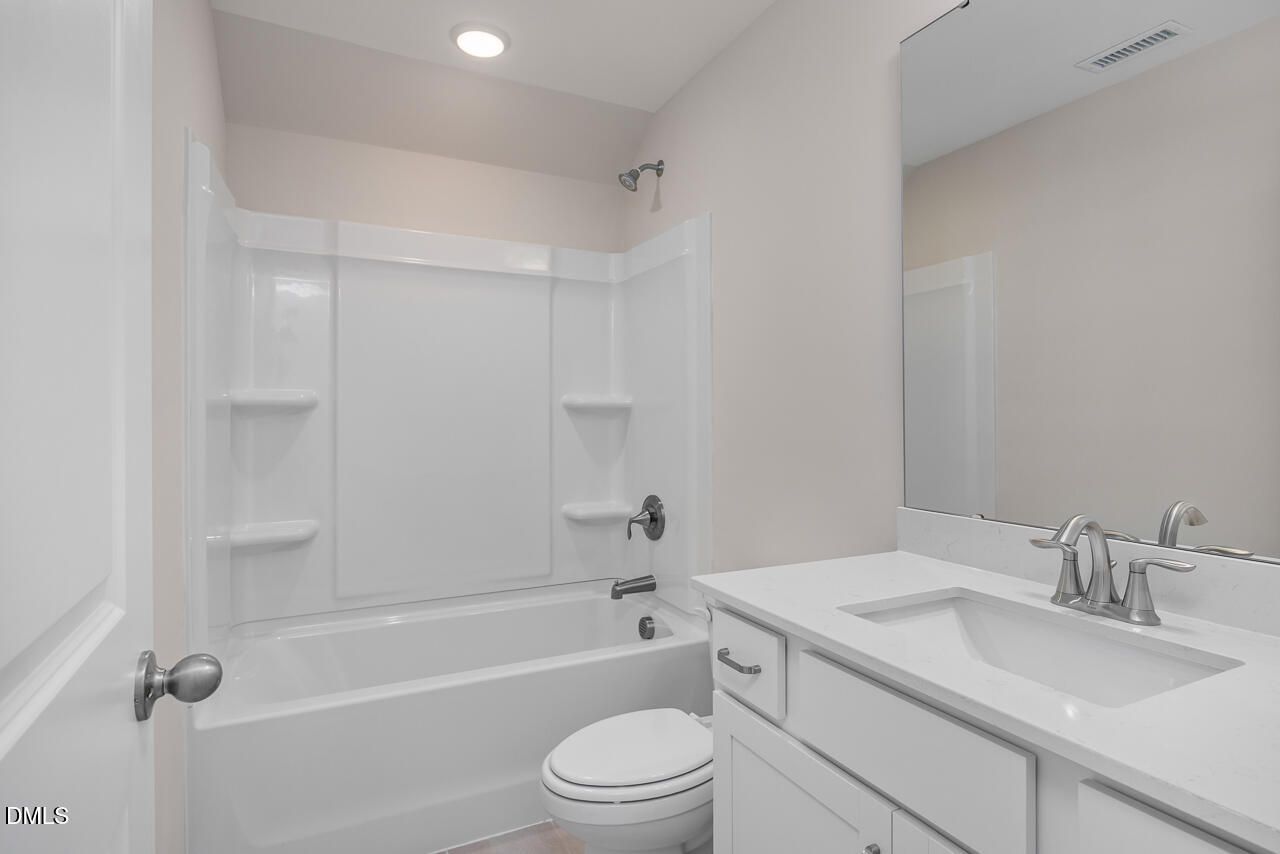 Modern full bathroom with white vanity, quartz countertop, and tub-shower combo in Hickory II C home, Montrose, Aberdeen.