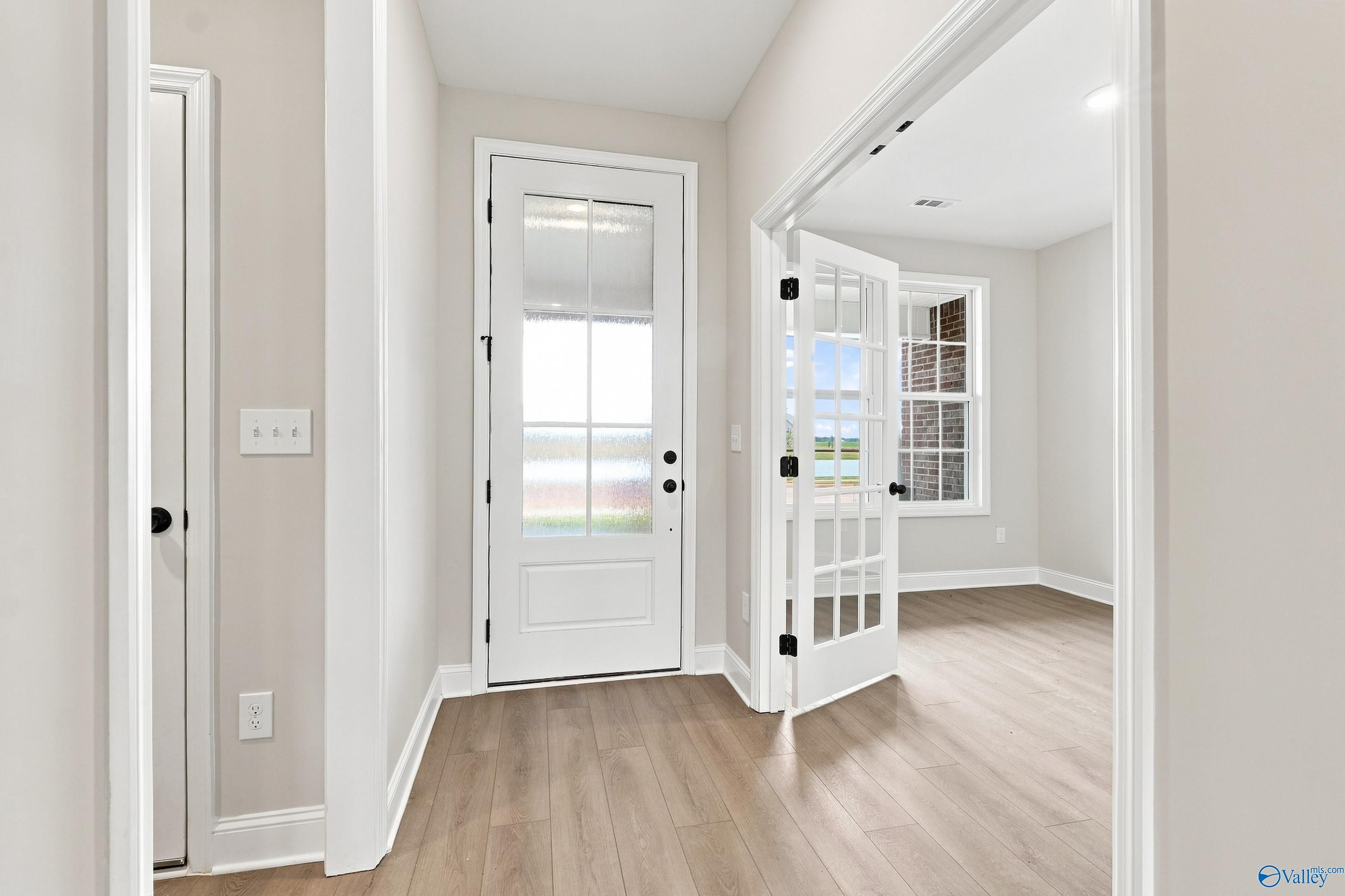 Entryway with glass-paneled door and French doors leading to home office in The Rockford B plan, Kendall Downs, Toney, AL.