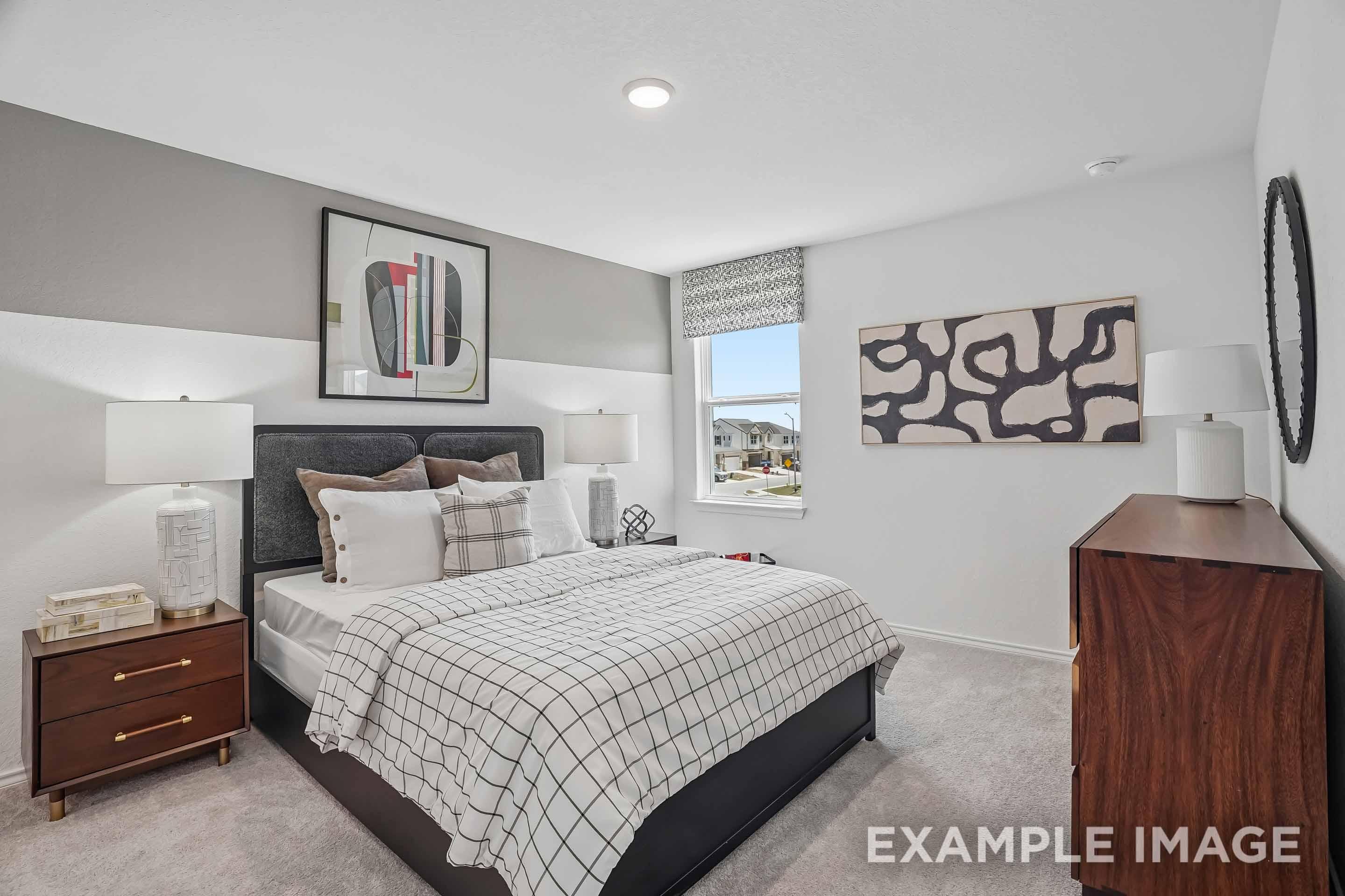 Modern master bedroom in The Pinecrest home design featuring a king bed, mid-century decor, and spacious main floor layout.