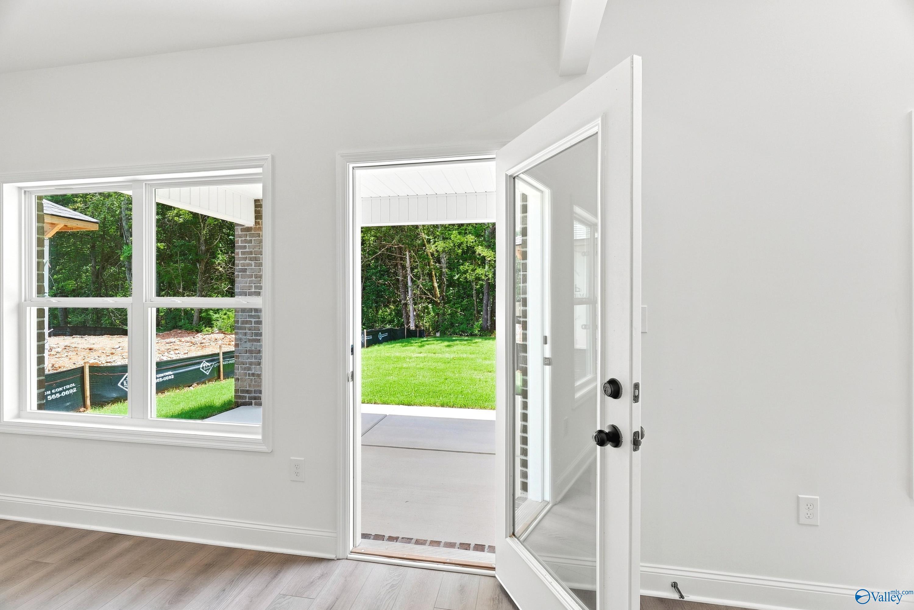 Open door leading to covered back patio and grassy backyard in The Shelby B floor plan at Jaguar Hills, Huntsville, Alabama.