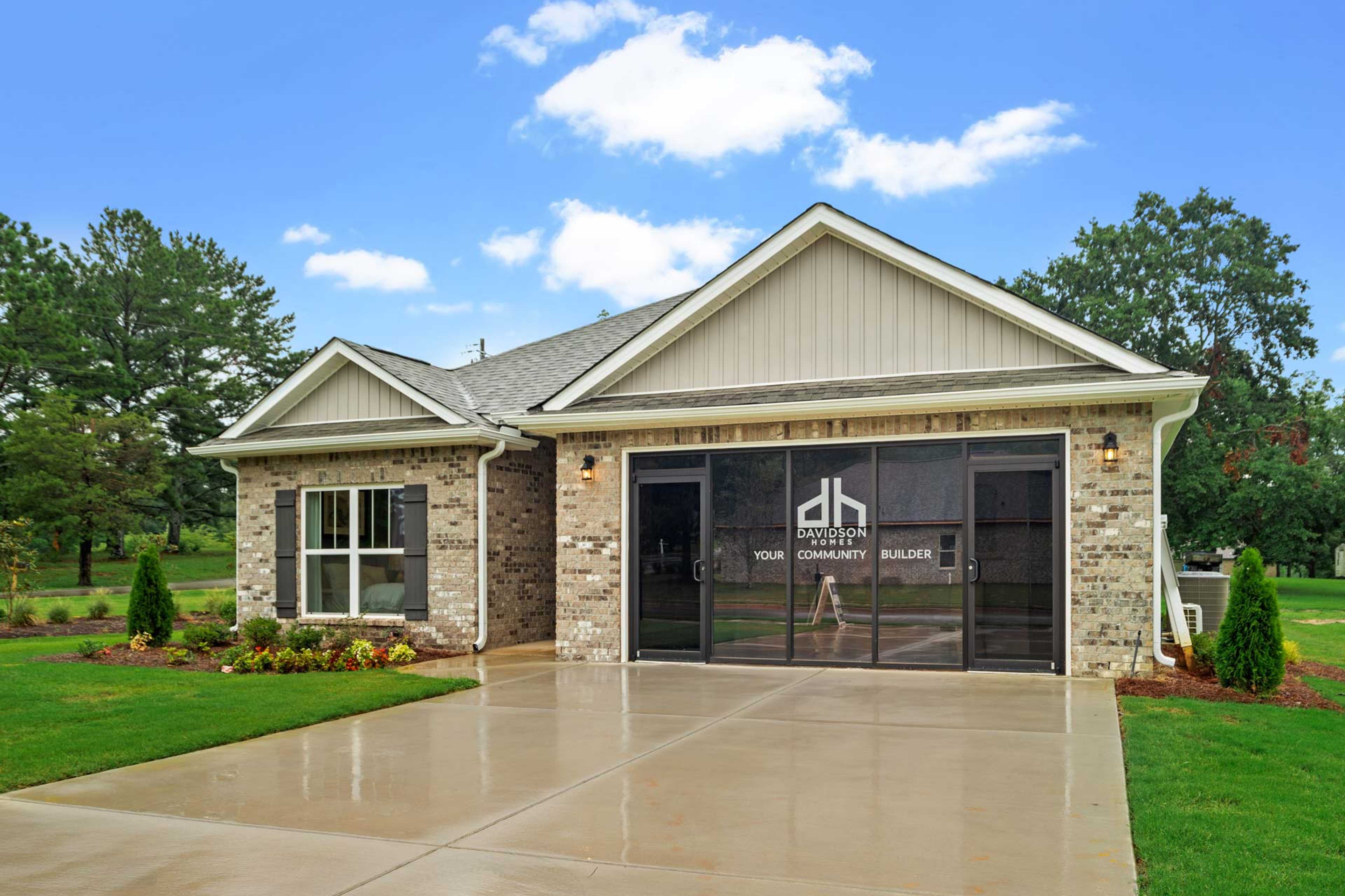 Modern ranch-style home exterior at Monteagle Cove in Owens Cross Roads AL by Davidson Homes featuring brick facade, two-car garage, and landscaped yard
