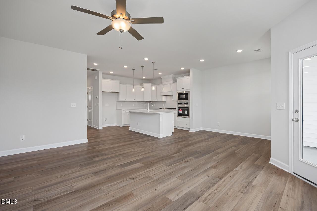Open-concept kitchen and living area in The Graham floor plan by Davidson Homes in Springvale, Fuquay-Varina, North Carolina.