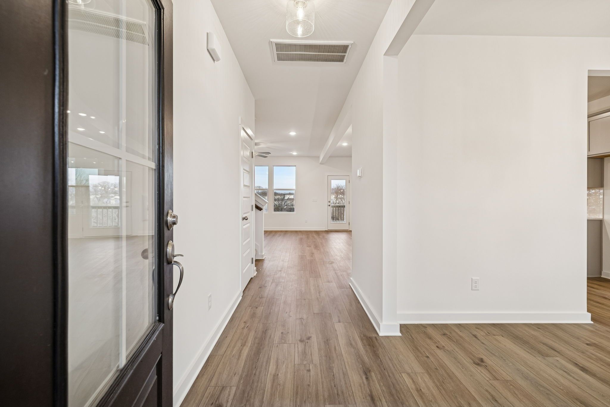 Bright entryway with wood-style flooring in The Willow B floor plan by Davidson Homes in Calista Farms, White House, TN.