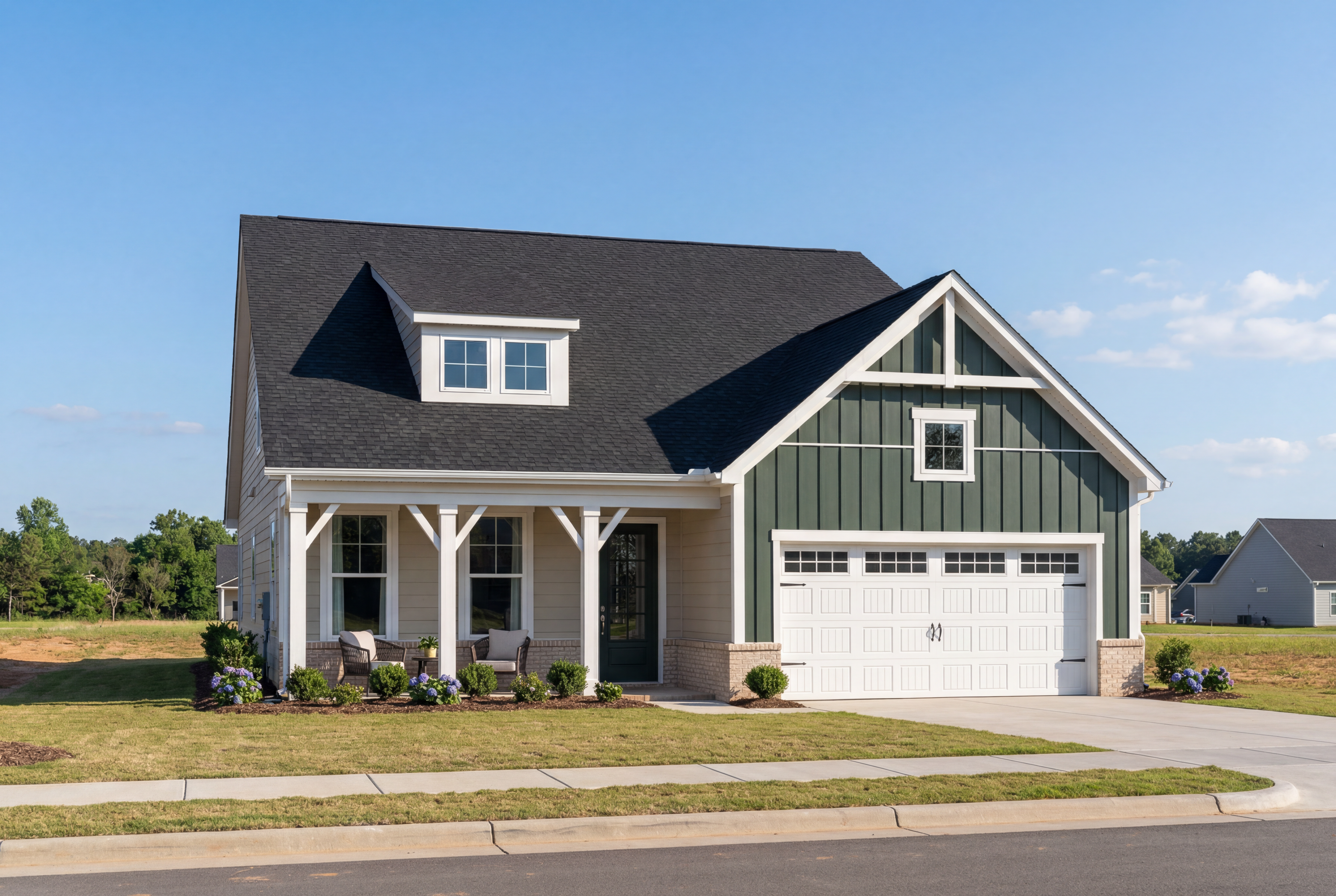 Two-story craftsman exterior of The Birch II B with black roof, sage green siding, covered porch, and two-car garage in Aberdeen NC
