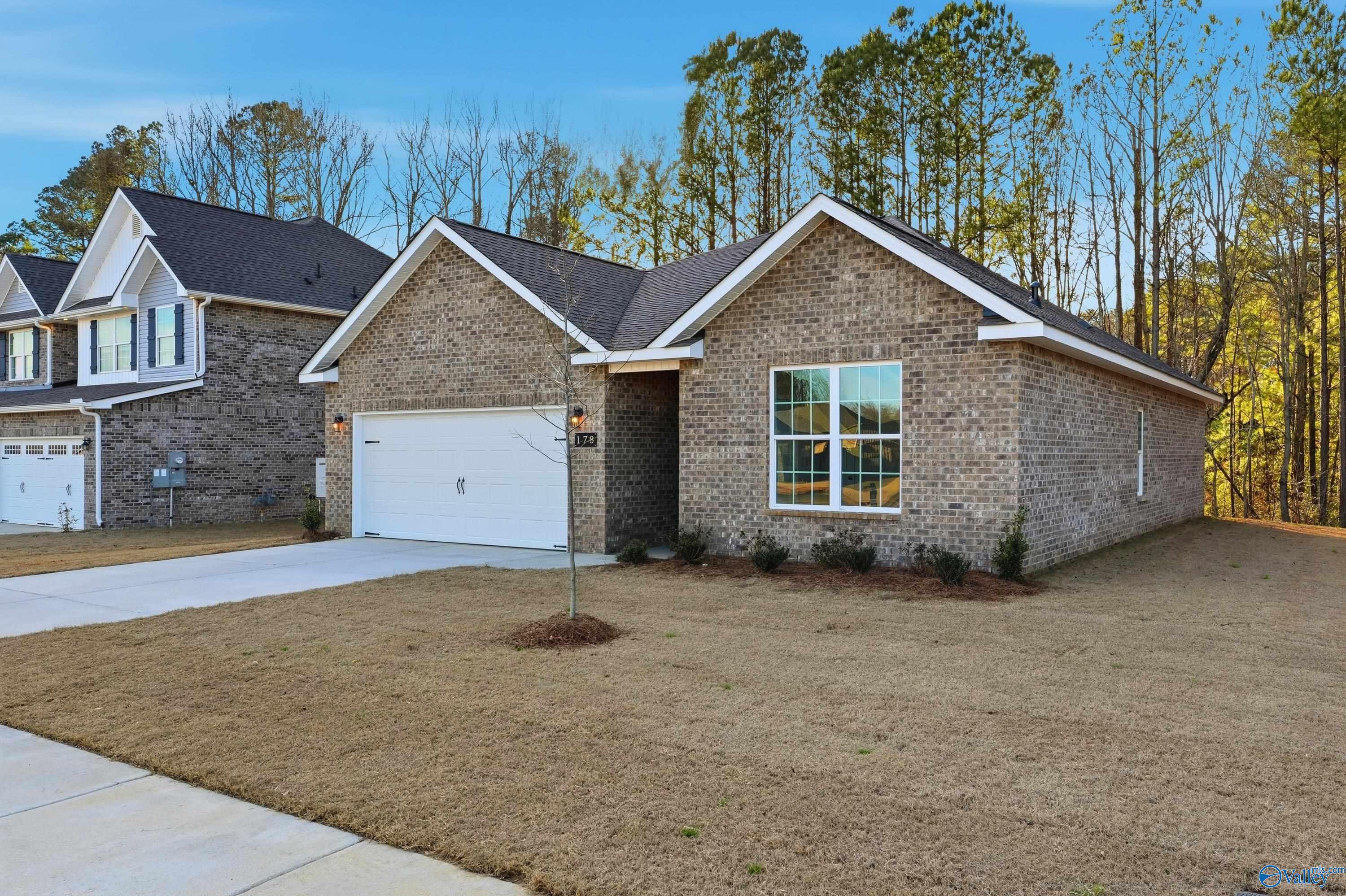 Single-story brick ranch home with 2-car garage, gabled roof, and driveway in The Highlands, Arab, Alabama - Davidson Homes Asheville