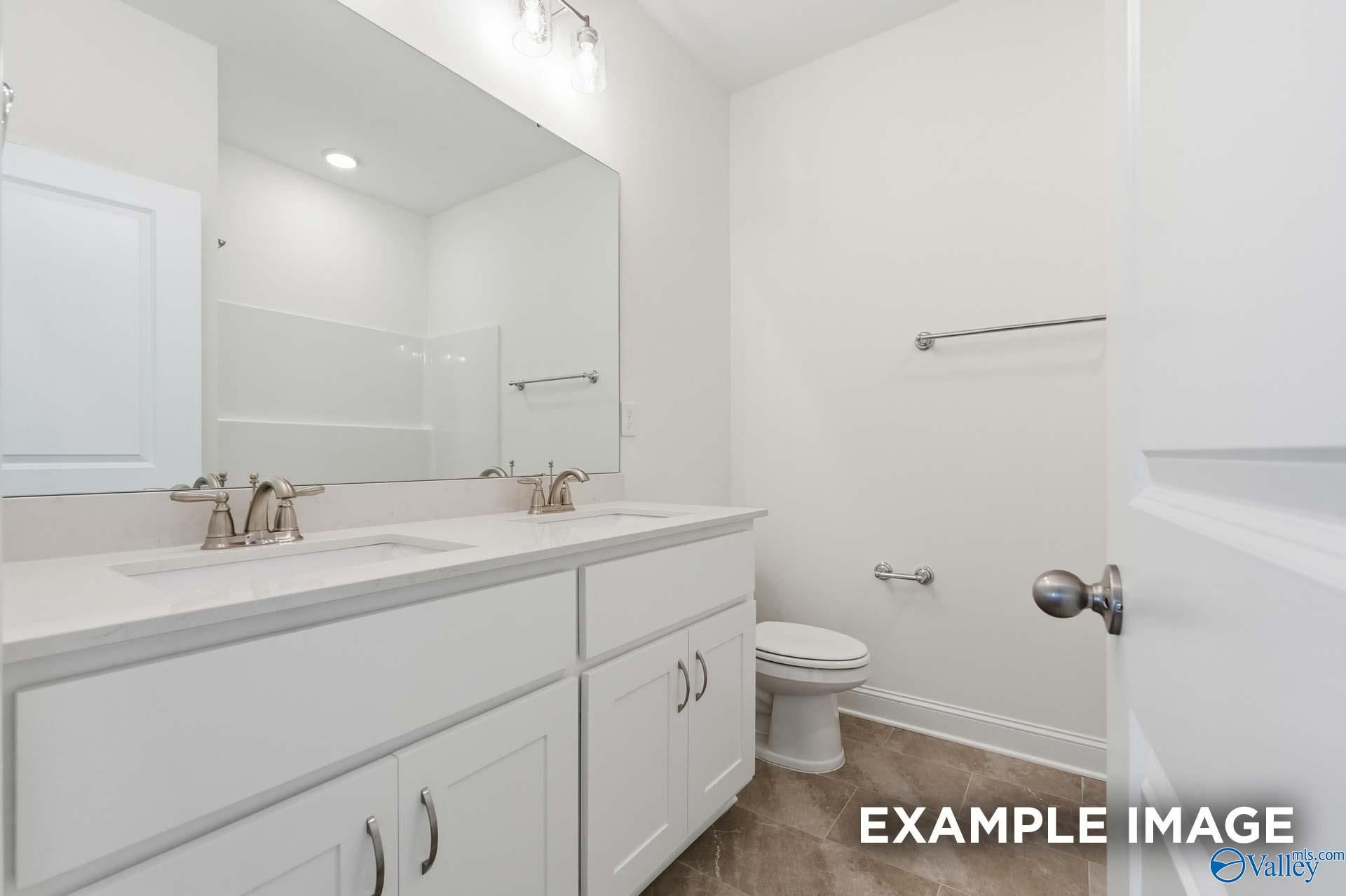 Modern double vanity bathroom with white cabinets in The Valencia floor plan by Davidson Homes in Briercreek, Meridianville.