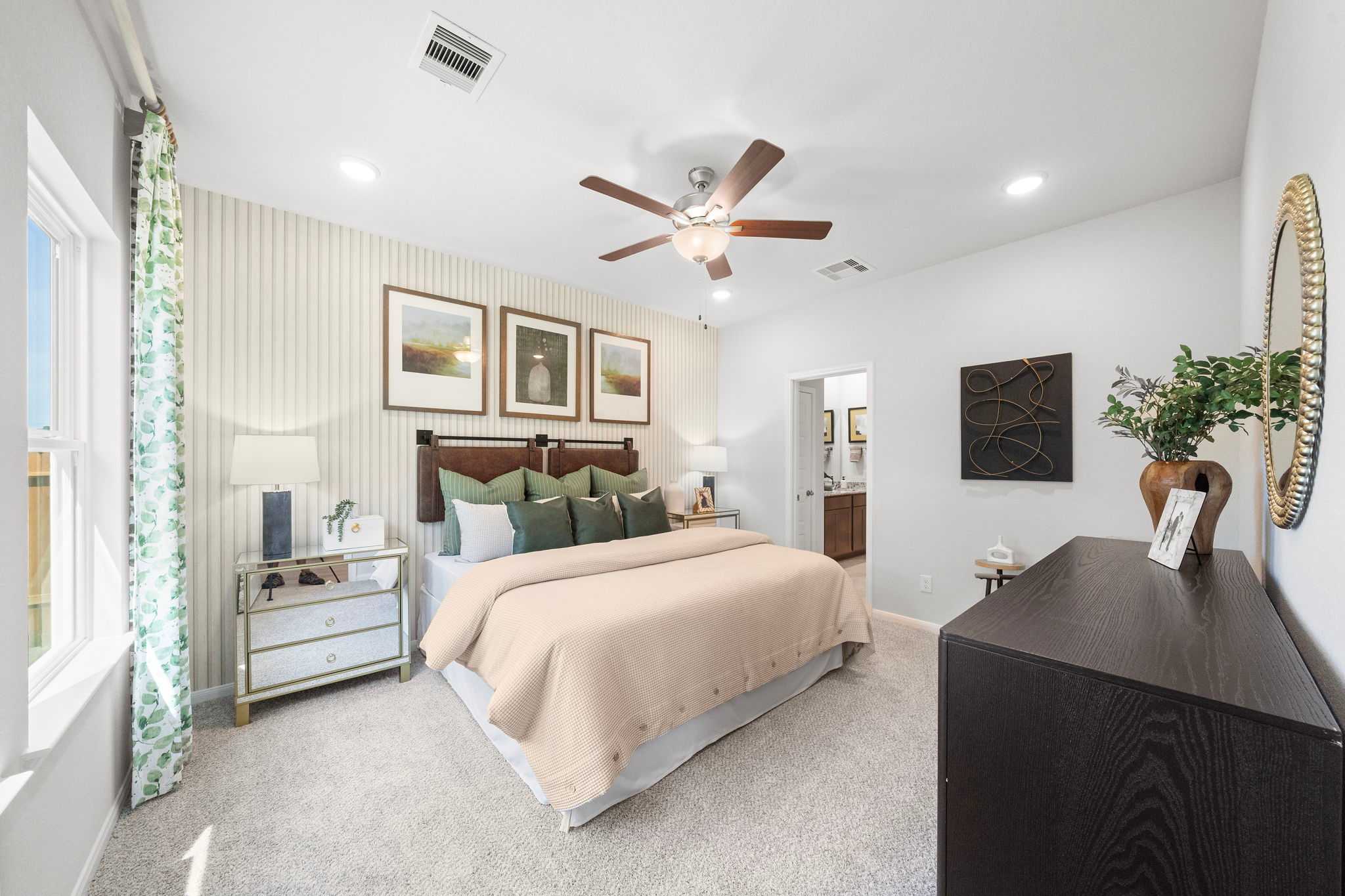Spacious primary bedroom at Caney Creek Place in Conroe Texas with king bed, ceiling fan, and neutral decor