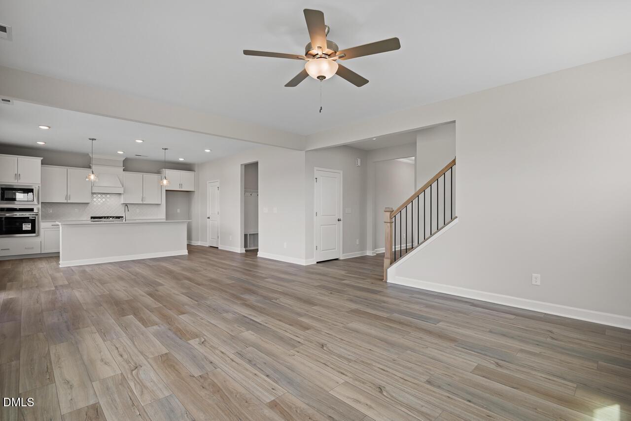 Open-concept living room and kitchen in The Chestnut floor plan by Davidson Homes at Wendell Ridge, Wendell, North Carolina.