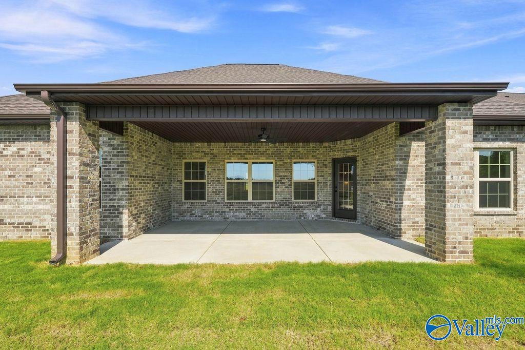 Covered brick patio with ceiling fan at The Rockford floor plan by Davidson Homes in Cain Park, Hartselle, Alabama.