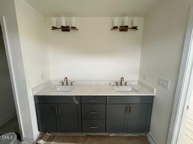 Double vanity with dark gray cabinets and bronze fixtures in The Hickory II B plan at Retreat at North Main, Lillington, NC.