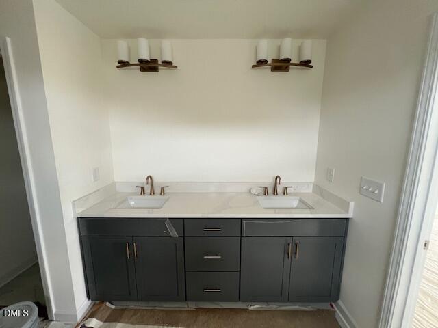 Double vanity with dark gray cabinets and bronze fixtures in The Hickory II B plan at Retreat at North Main, Lillington, NC.