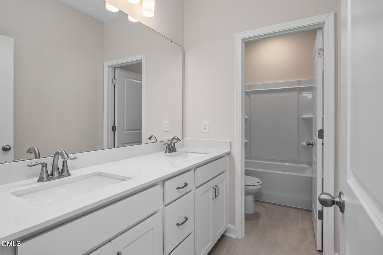 Modern bathroom with dual-sink vanity and tub-shower combo in The Hickory II C floor plan at Montrose, Aberdeen, NC.