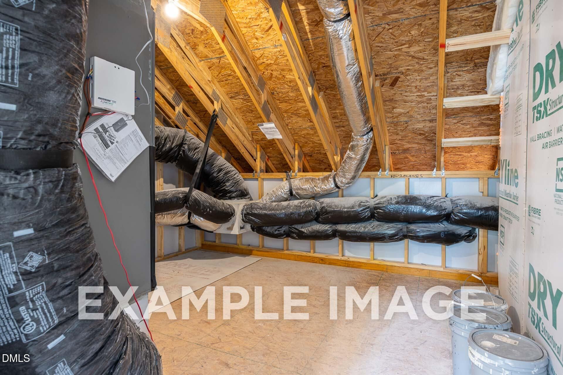 HVAC ductwork and exposed wooden beams in unfinished interior of 3-bedroom The Ash B home by Davidson Homes, Zebulon, NC