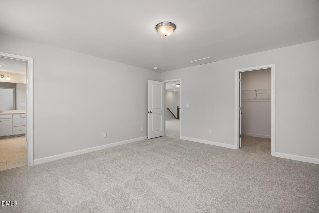 Spacious bedroom with en-suite bath and walk-in closet in The Adalynn A floor plan at Gregory Village, Lillington, NC.
