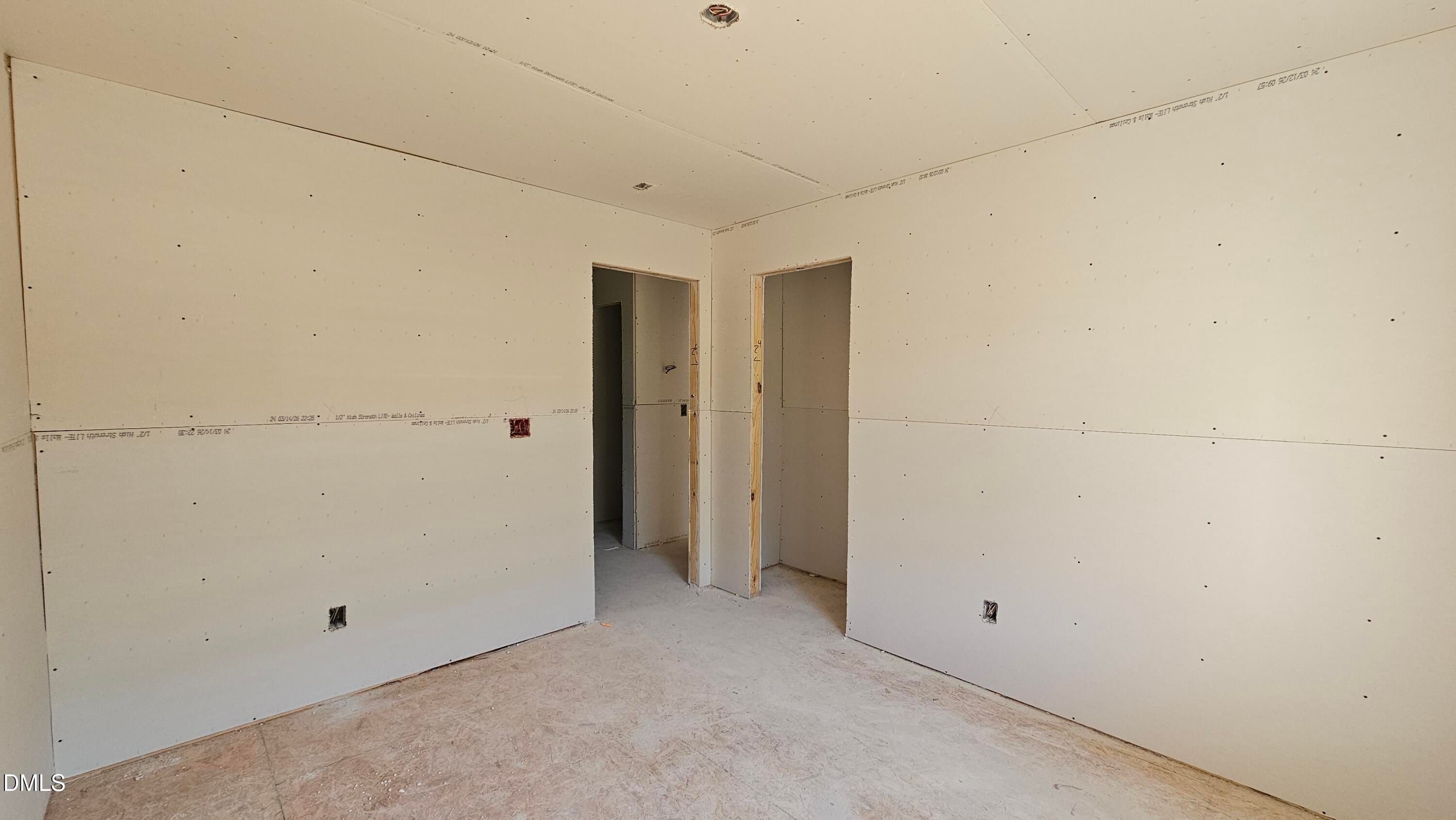 Unfinished bedroom with drywall installation in The Graham floor plan at Springvale, Fuquay-Varina, North Carolina.