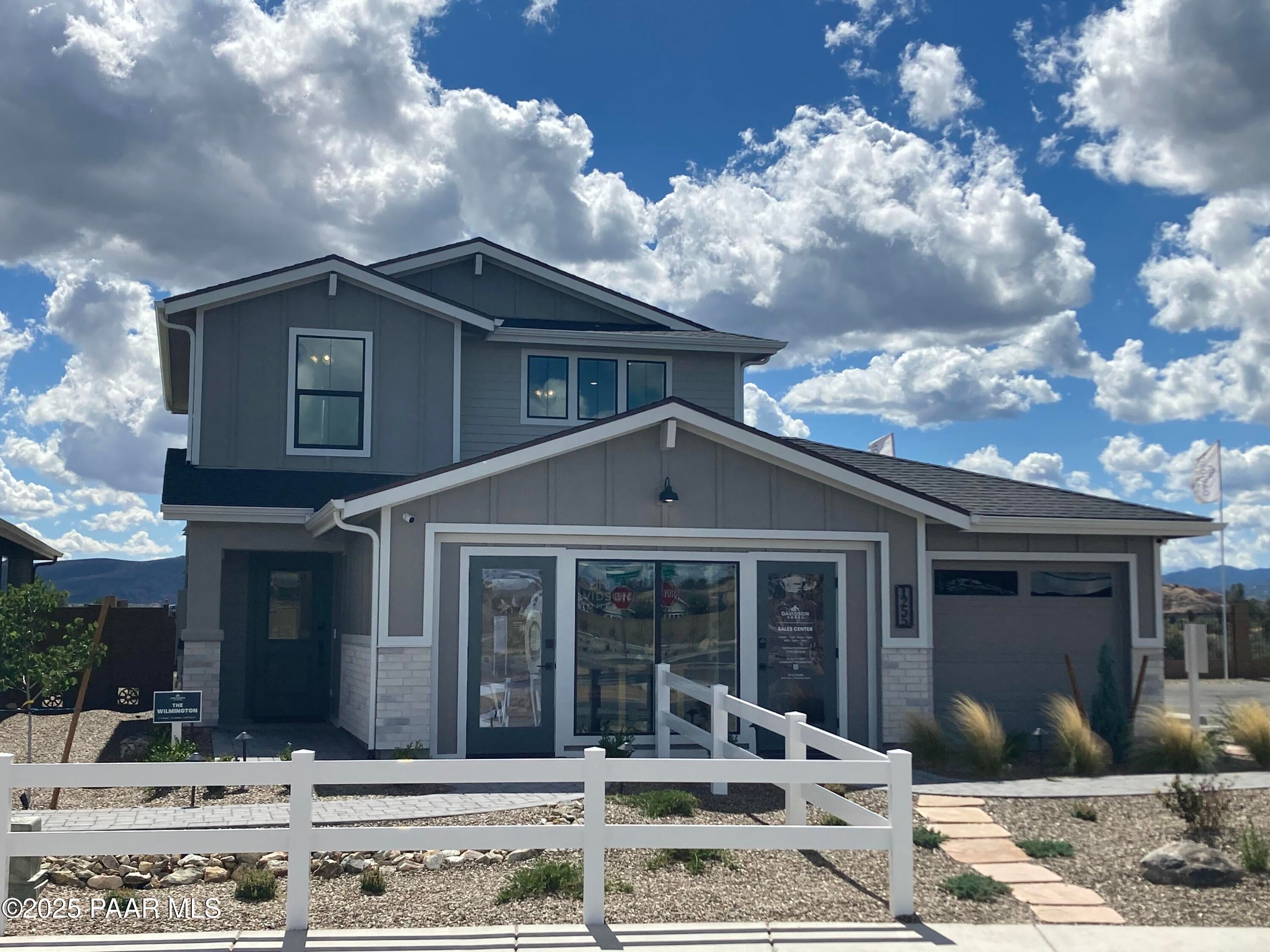 Modern two-story gray home with 3-car garage, glass doors, and desert landscaping in South Ranch, Prescott, Arizona - Davidson Homes Wilmington B