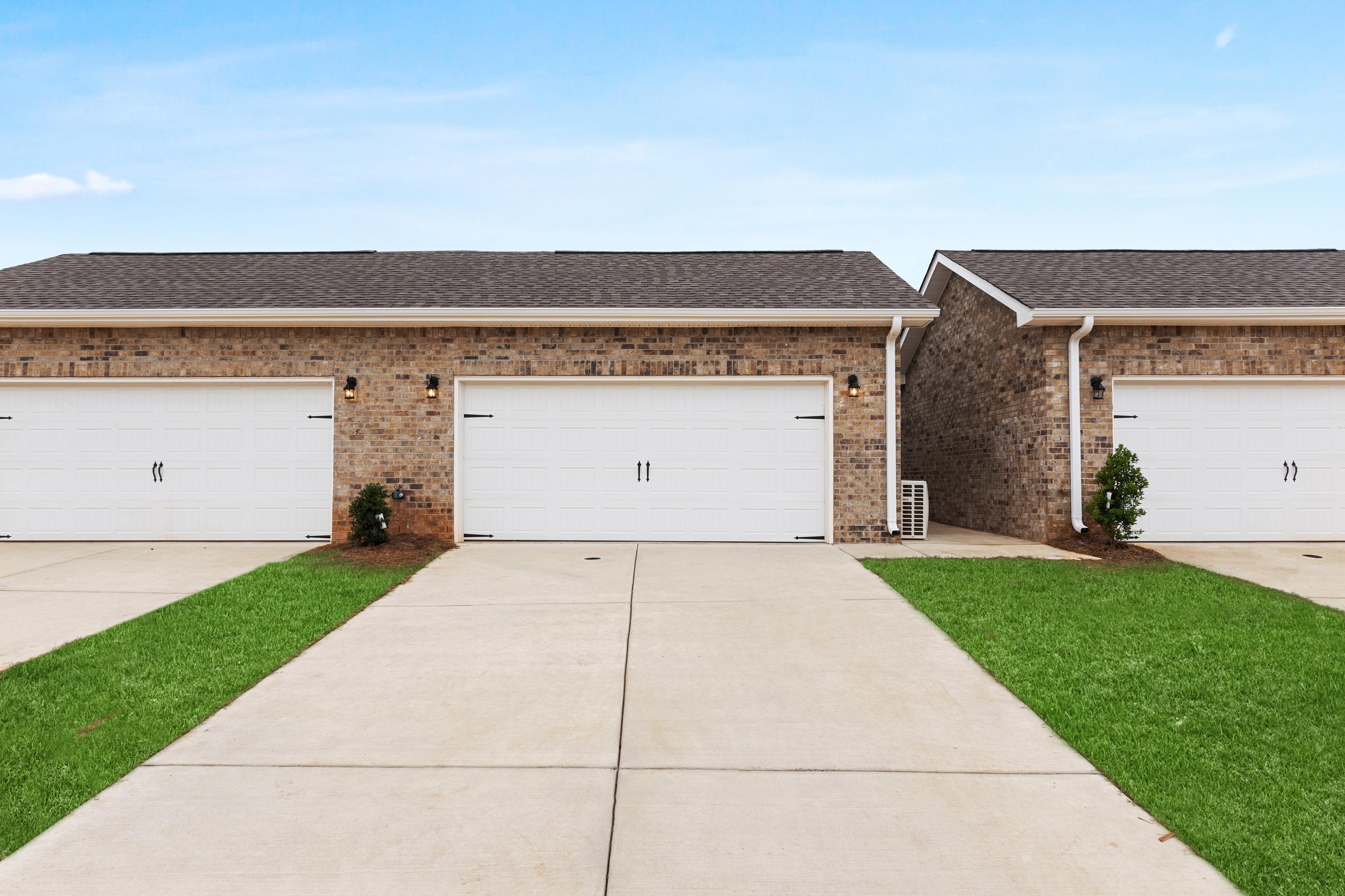 The Copeland C multi-family home exterior featuring brick facade, attached 2-car garages, and concrete driveway in Madison, AL