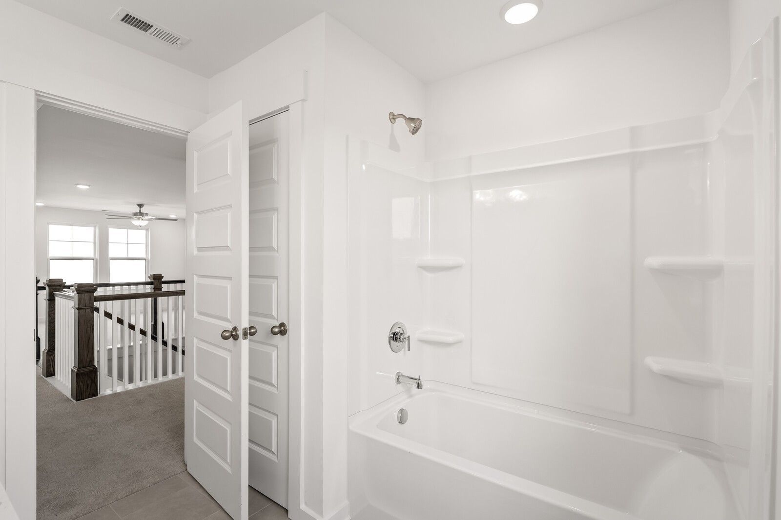 Modern bathroom with white tub-shower combo in The Willow D floor plan at Benders Cove, Mt. Juliet, Tennessee.