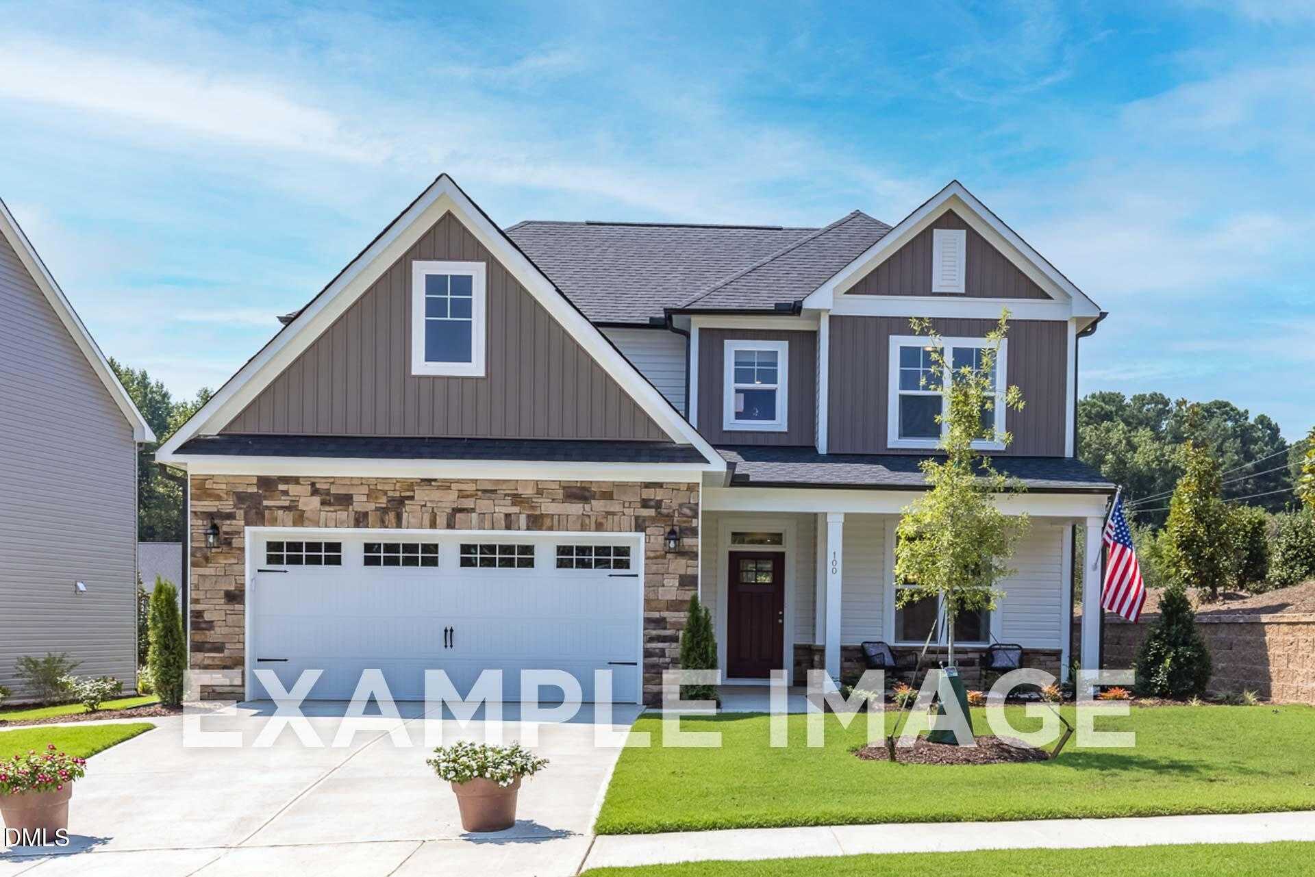 Modern two-story Davidson Homes The Ash B with stone facade, two-car garage, and front porch in Wellers Knoll, Lillington, NC