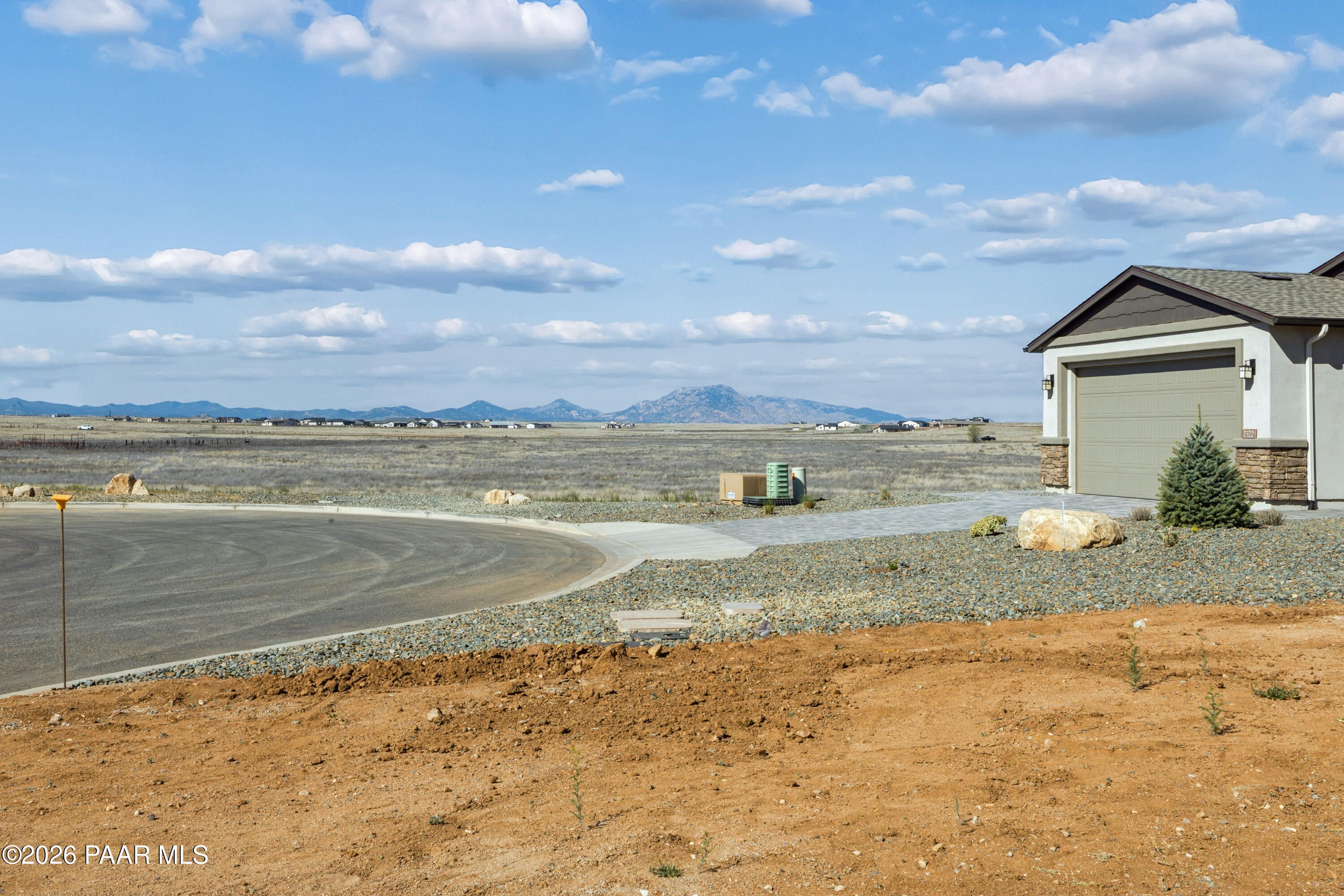 Modern single-story home with 3-car garage in North Ridge at Pronghorn Ranch, Prescott Valley, AZ, desert mountain backdrop