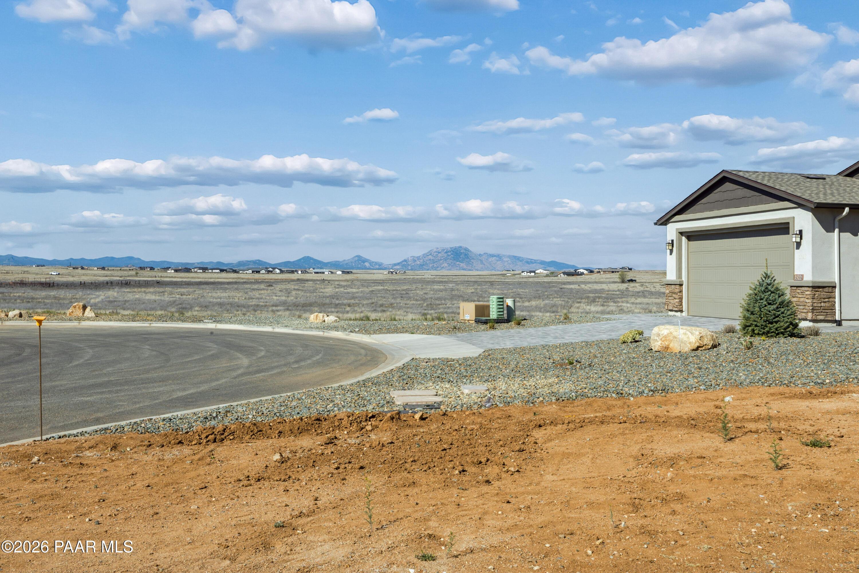 Modern single-story home with 3-car garage in North Ridge at Pronghorn Ranch, Prescott Valley, AZ, desert mountain backdrop