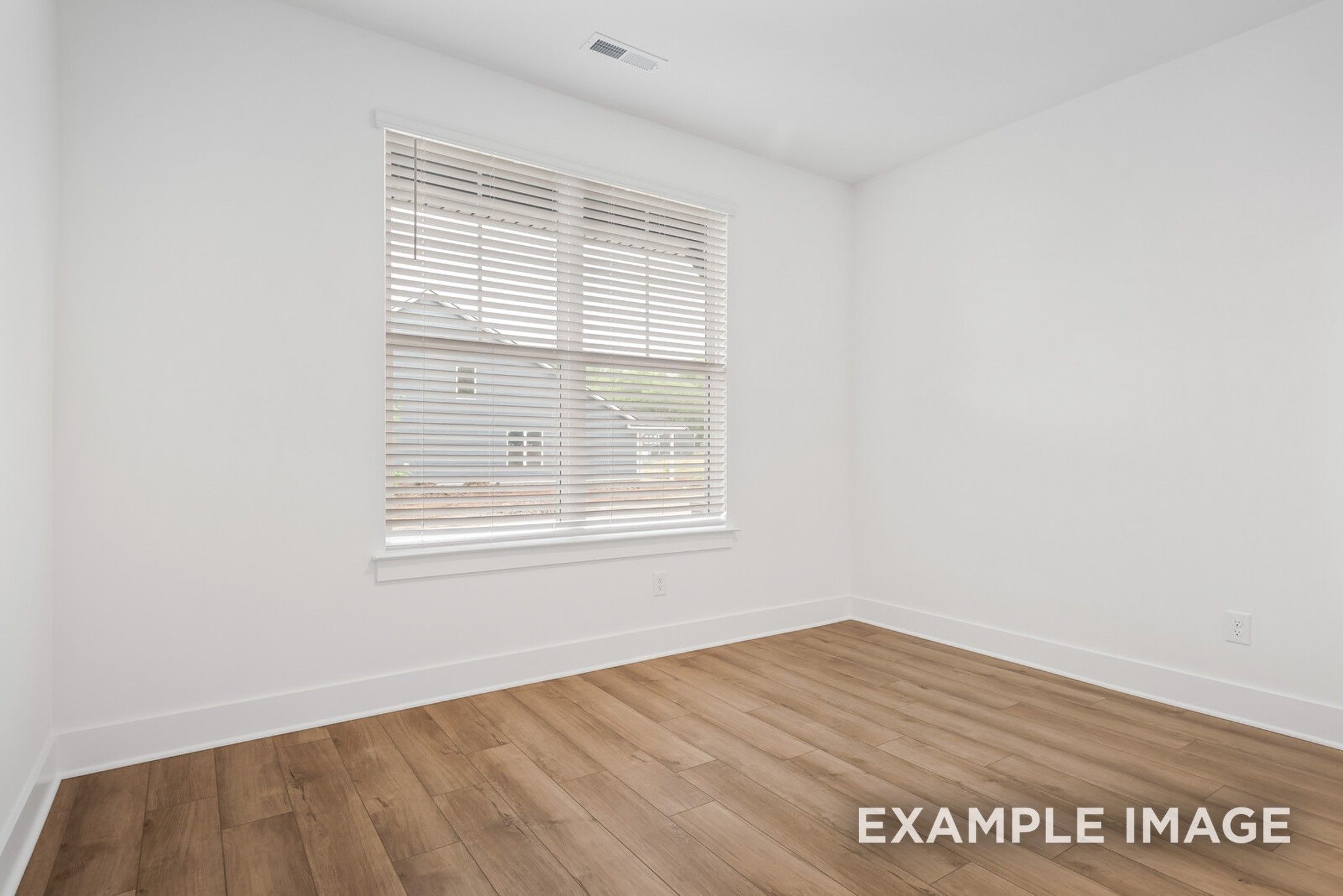 Bright secondary bedroom with light hardwood floors, white walls, and large window in 5-bedroom Ridgeport C home, Gallatin, TN