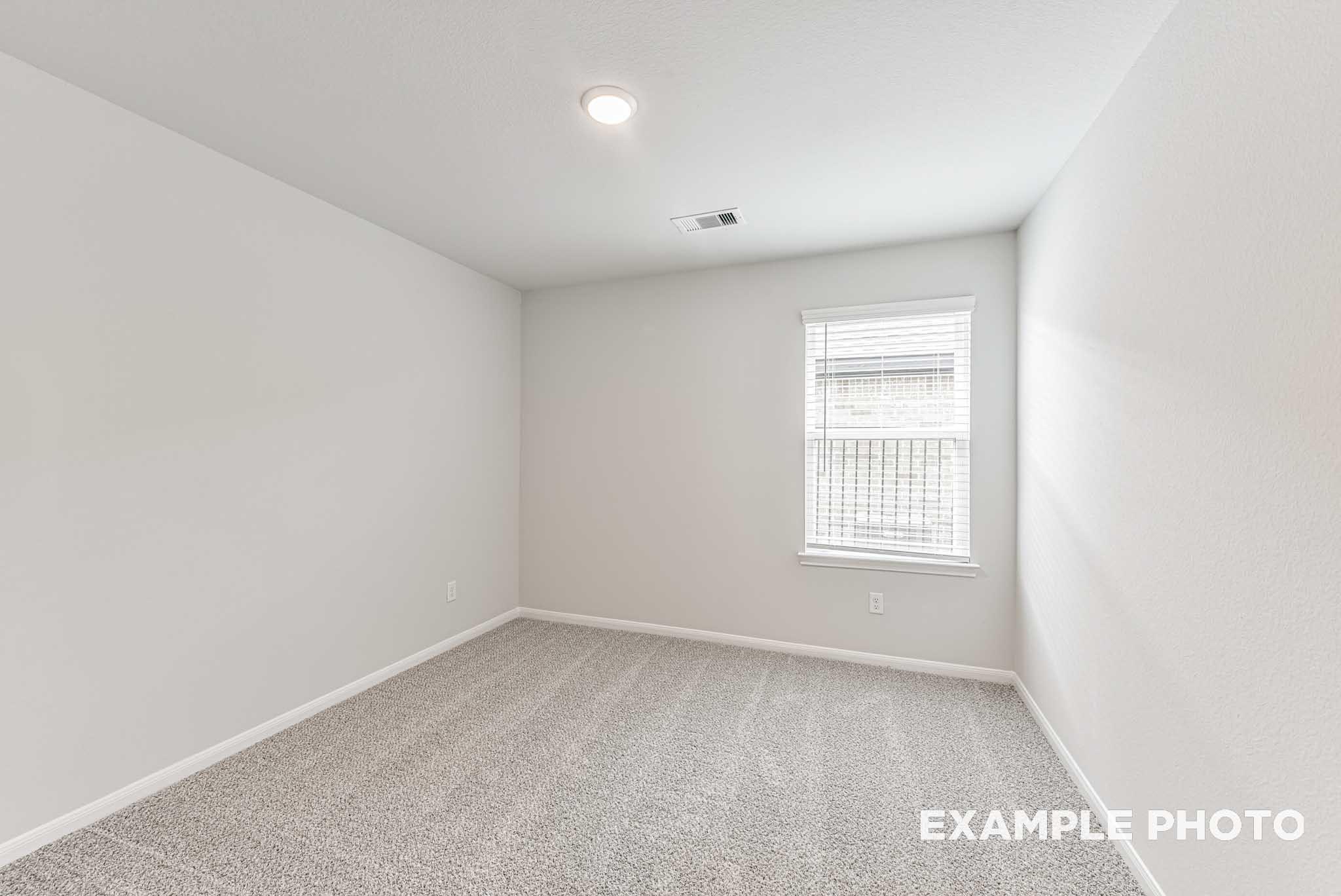 Empty secondary bedroom with neutral walls, carpet floor, window blinds, and recessed lighting in Davidson Homes The Riviera A, Rosharon, Texas