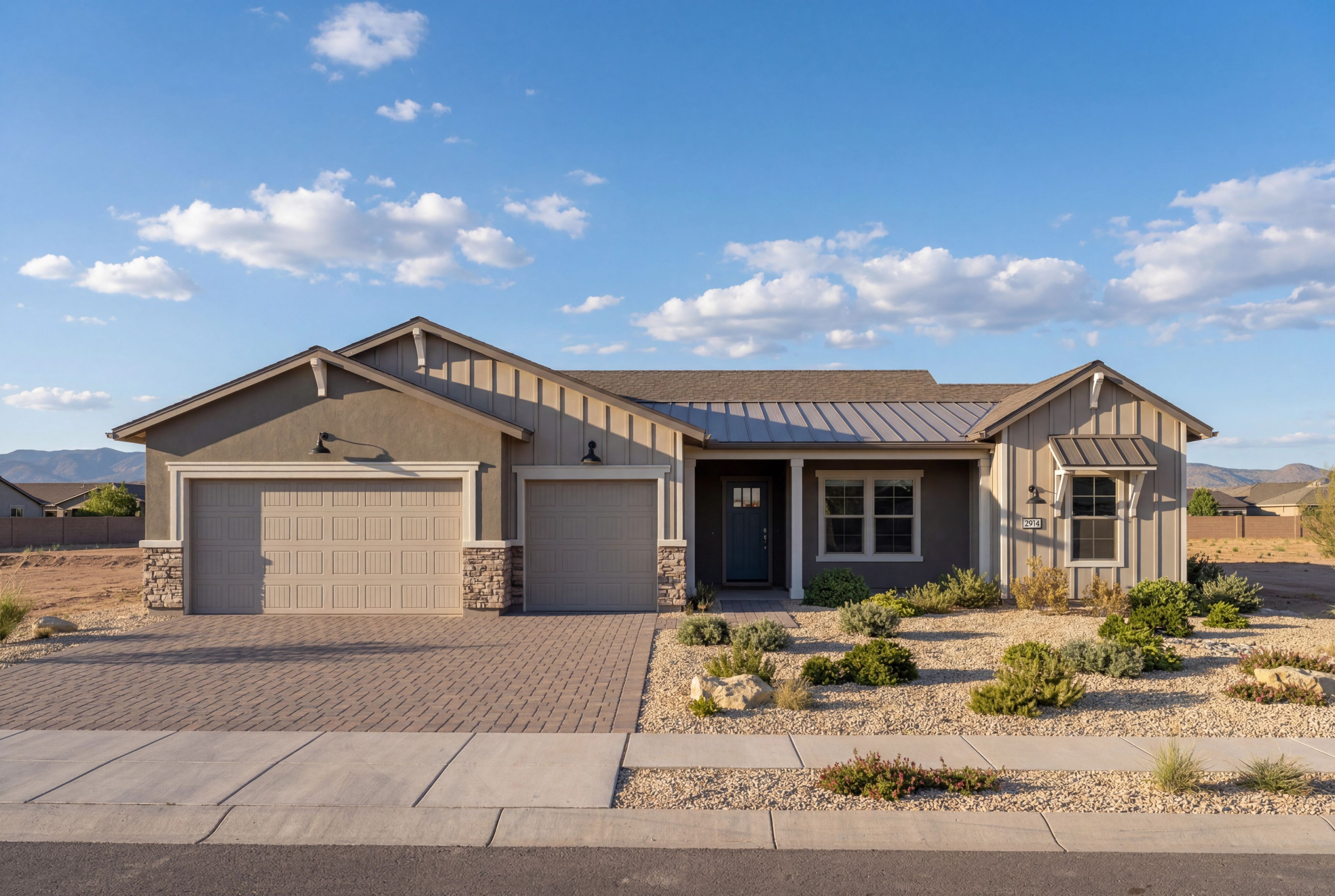 Modern farmhouse elevation of The Blaze E with a 3-car garage, stone accents, and desert landscaping in Prescott, Arizona.