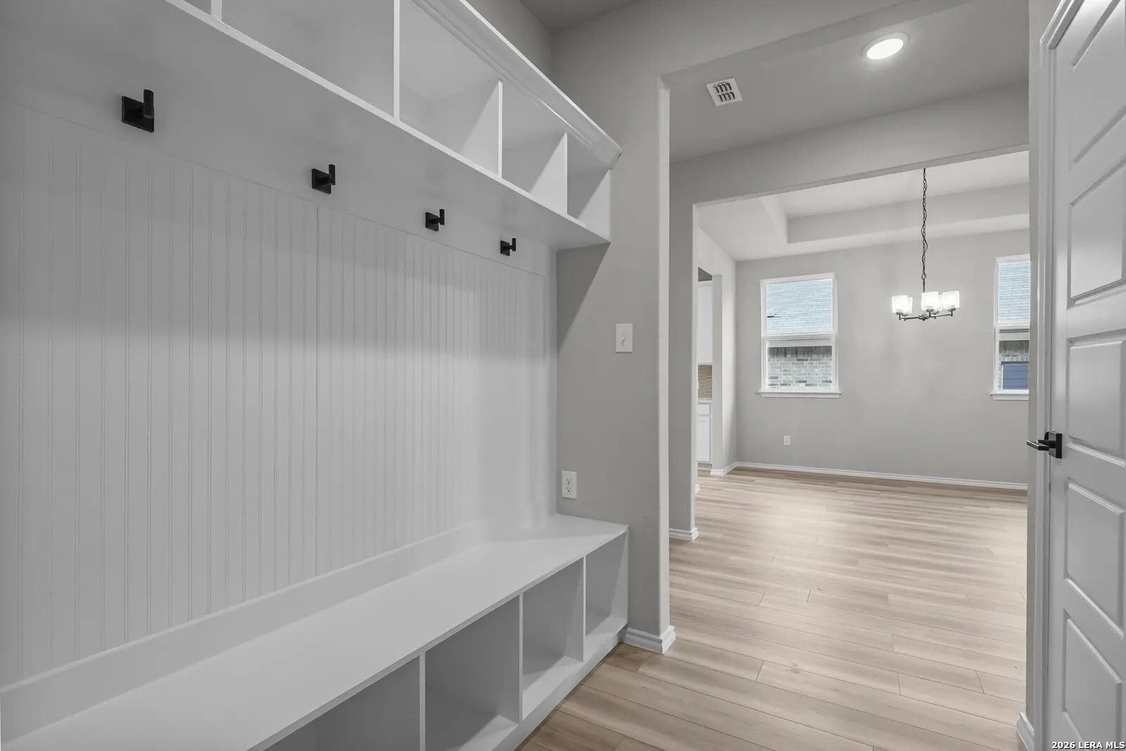Modern mudroom with built-in bench and storage in The Glenwood E floor plan by Davidson Homes in San Antonio, Texas.