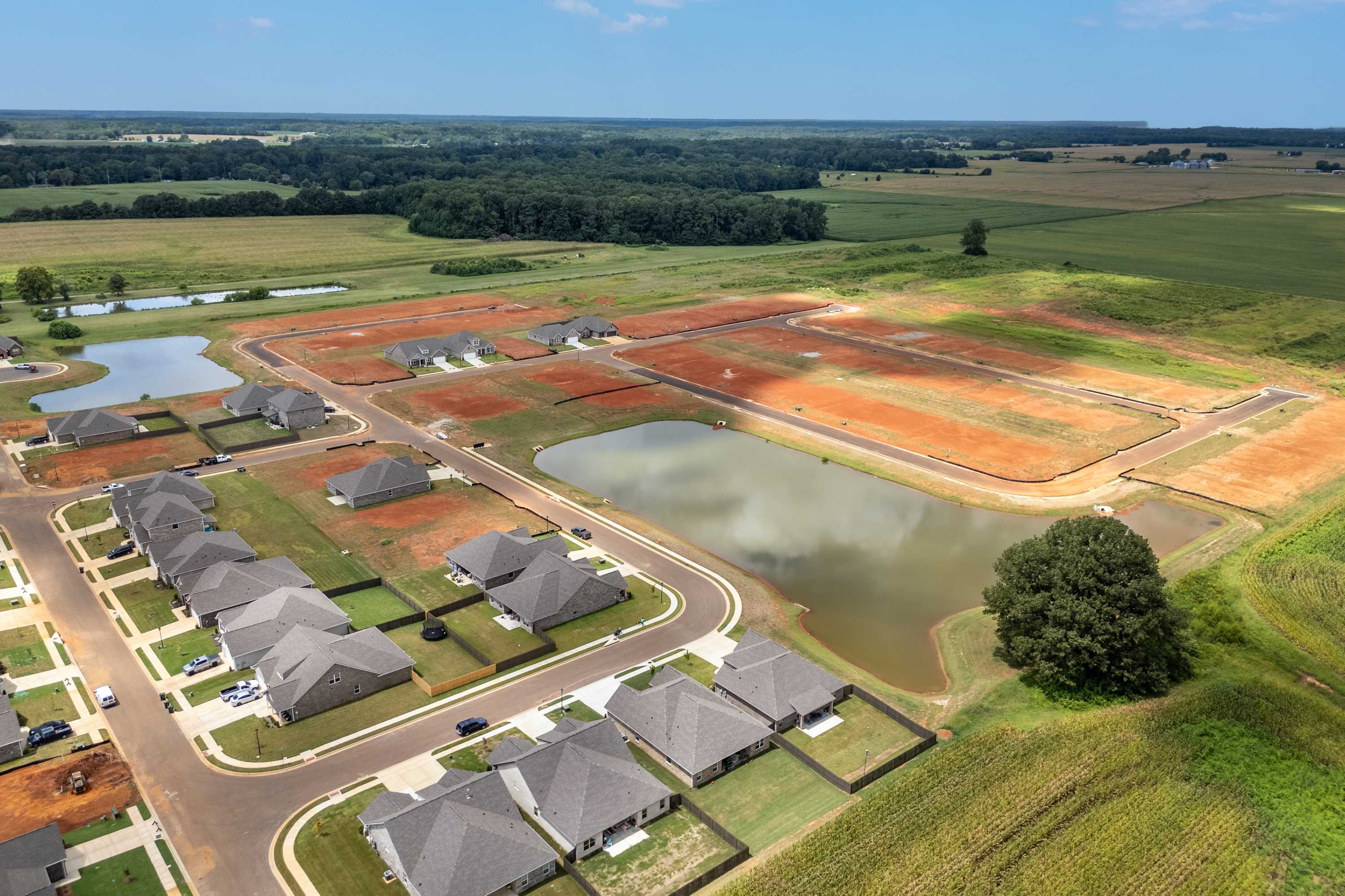 Aerial view of Kendall Downs in Toney Alabama by Davidson Homes with new homes, serene ponds, and expansive farmlands