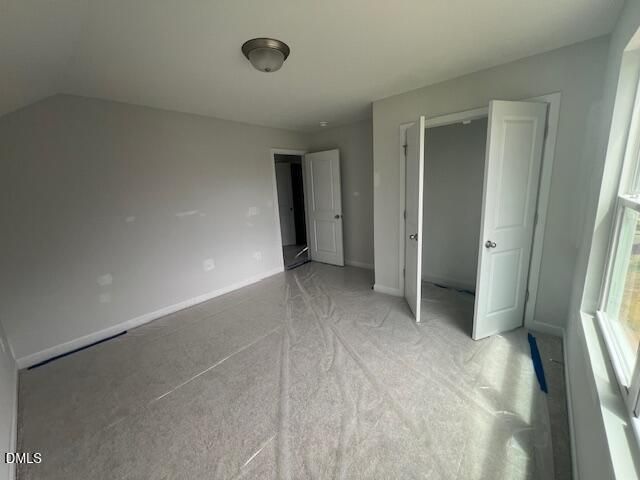 Spacious carpeted bedroom with double-door closet in The Ash B floor plan at Retreat at North Main, Lillington, NC.